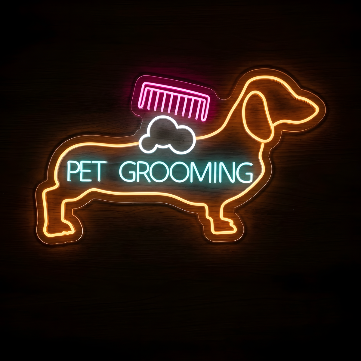 Dachshund Pet Grooming LED Neon Sign featuring an orange dachshund outline with a pink grooming comb, white soap suds, and aqua PET GROOMING lettering on clear acrylic backing against a dark wood wall.
