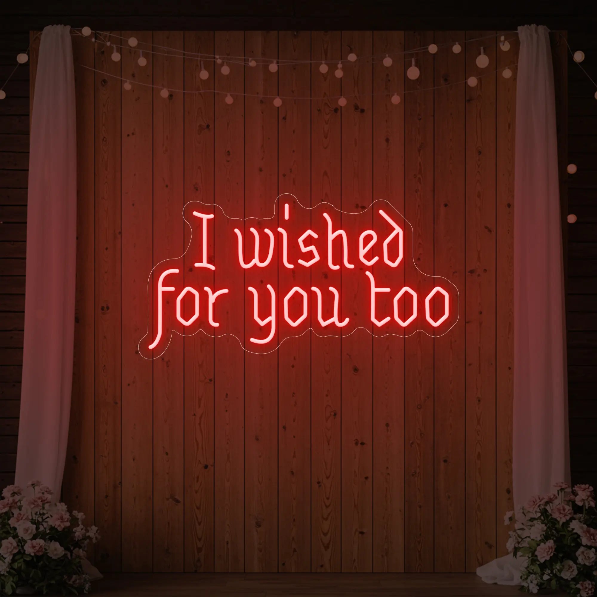 Photo of the 'I Wished For You Too' neon sign glowing in red against a styled interior wall.
