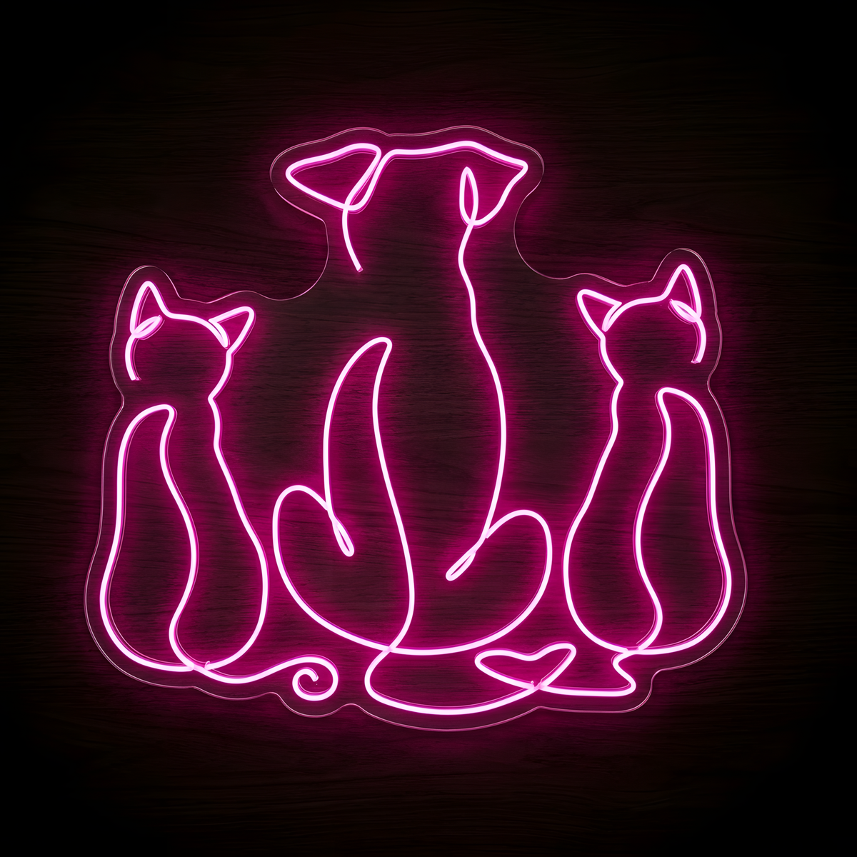 Three Best Friends LED Neon Sign featuring a bright pink line-art silhouette of one dog sitting between two cats on clear acrylic backing against a dark wood wall, creating playful pet lover decor.
