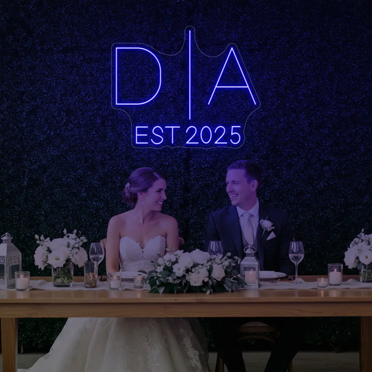 Photo of the 'Wedding Initials Custom Neon Sign V3' neon sign glowing in deep blue against a styled interior wall.