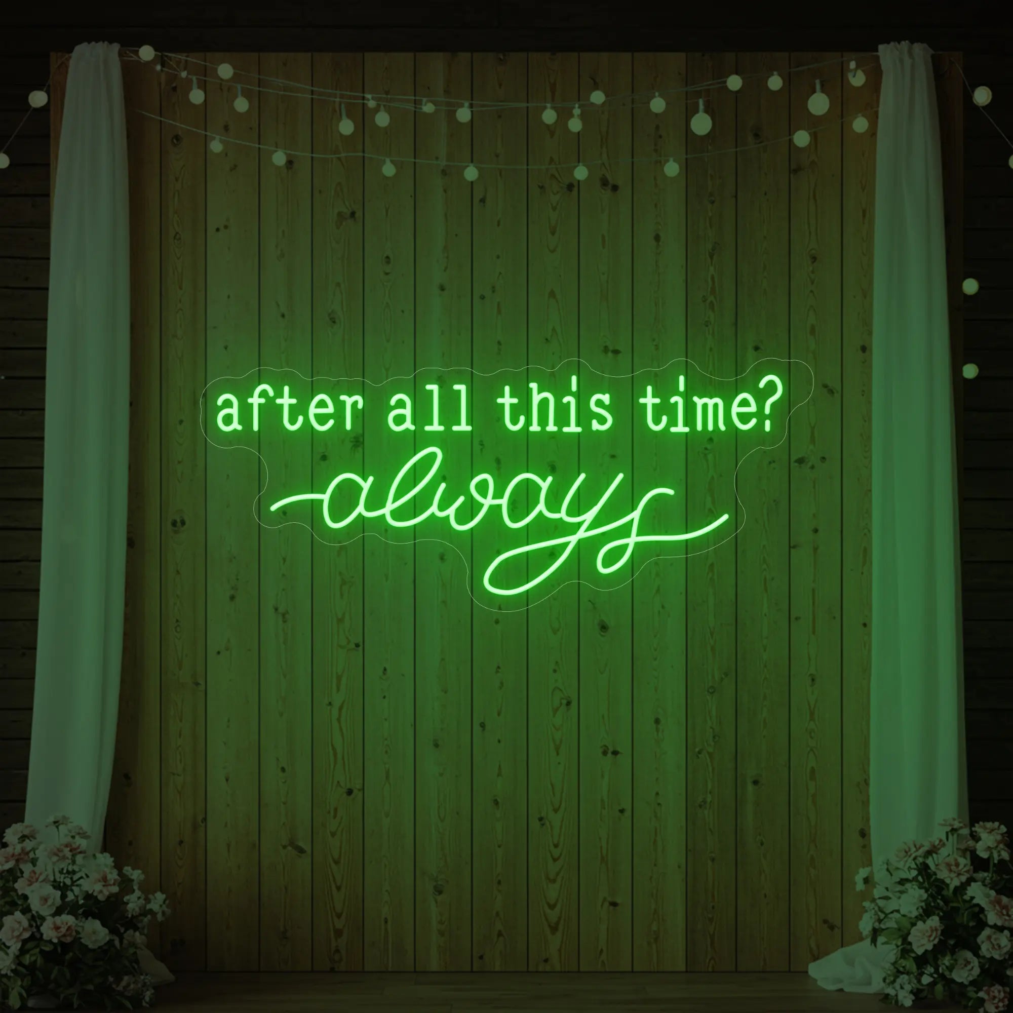 Photo of the 'After All This Time V1' neon sign glowing in green against a styled interior wall.