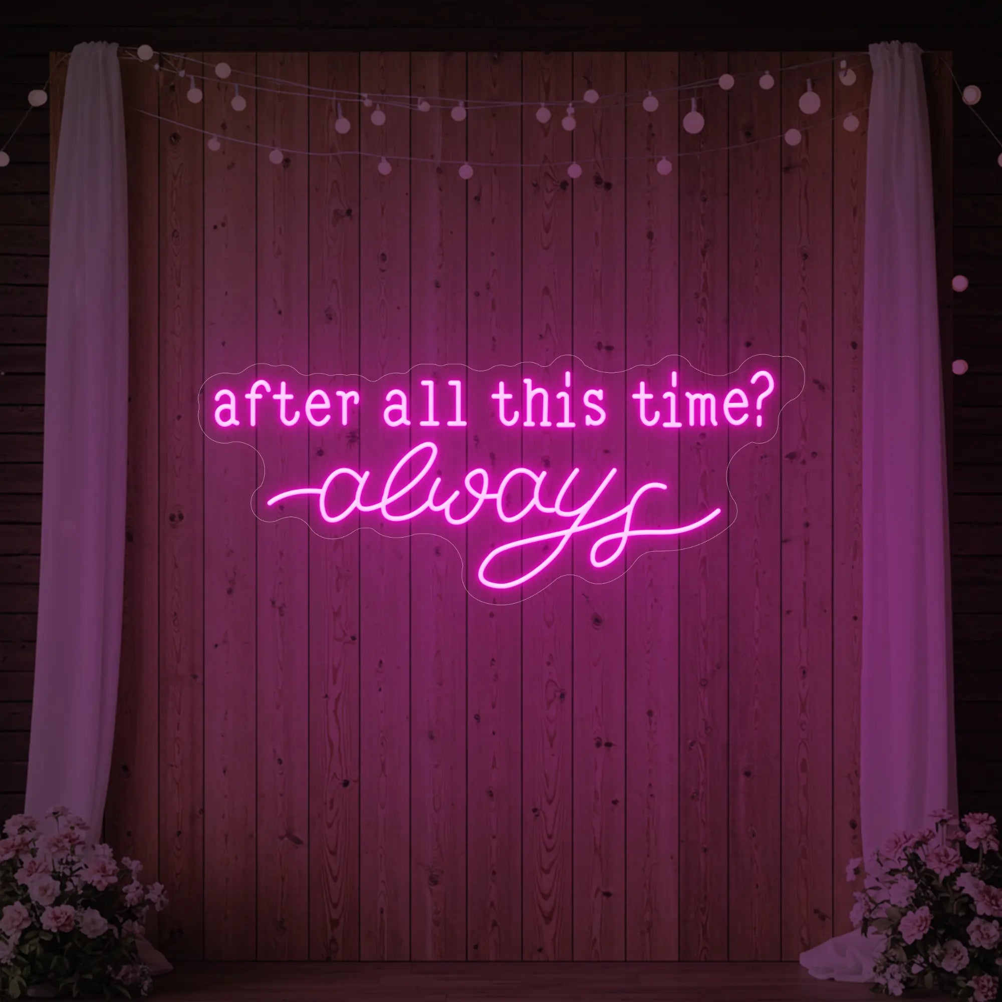 Photo of the 'After All This Time V1' neon sign glowing in light pink against a styled interior wall.