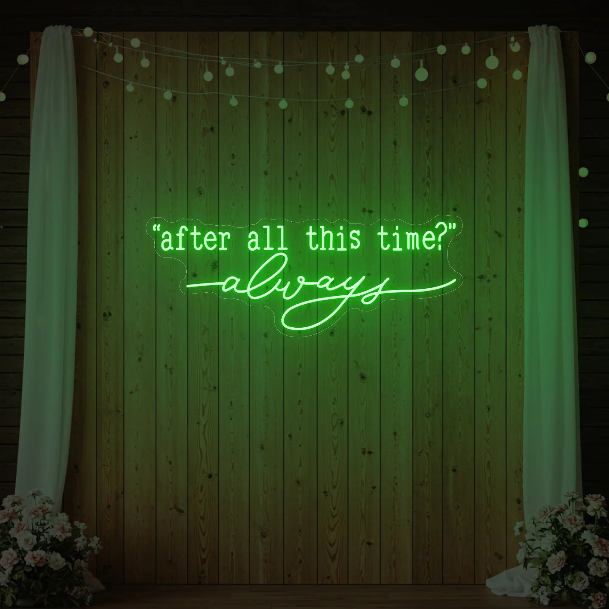 Photo of the 'After All This Time V2' neon sign glowing in green against a styled interior wall.