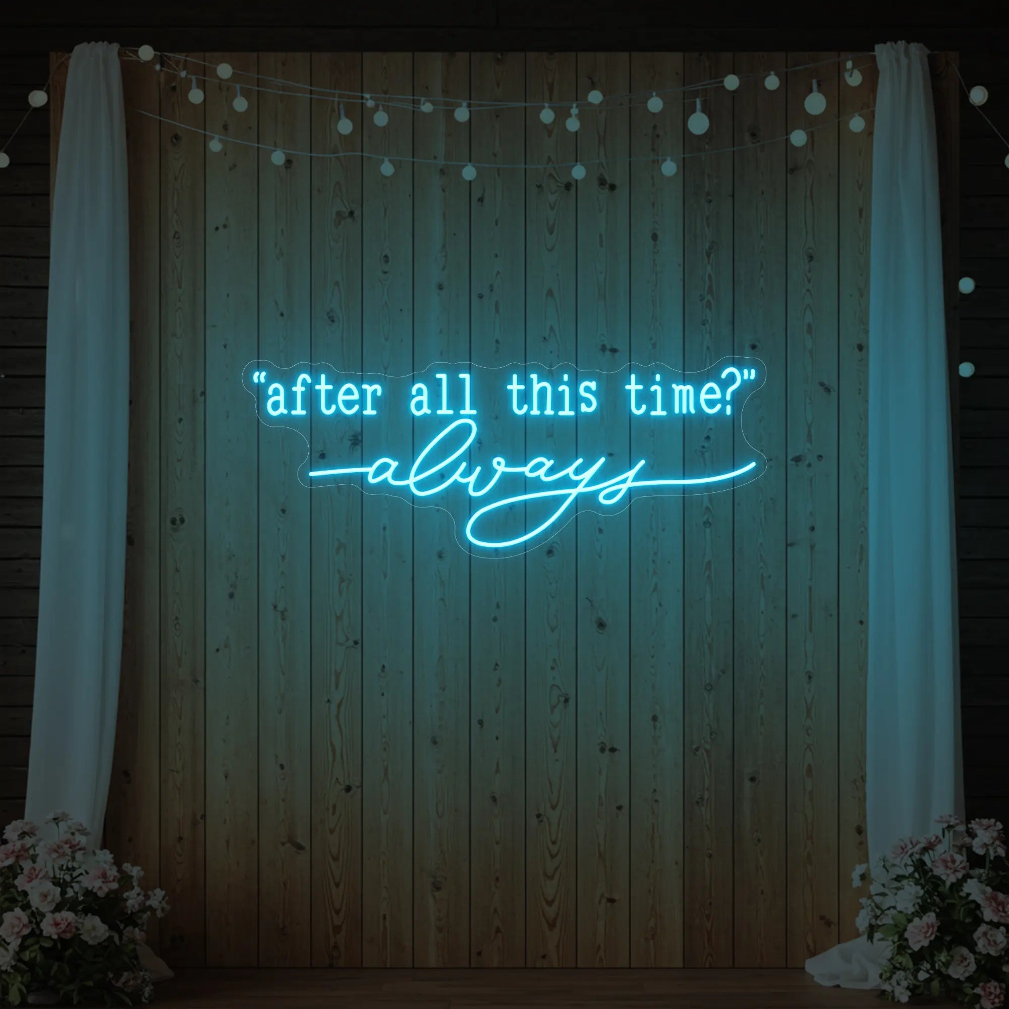 Photo of the 'After All This Time V2' neon sign glowing in ice blue against a styled interior wall.