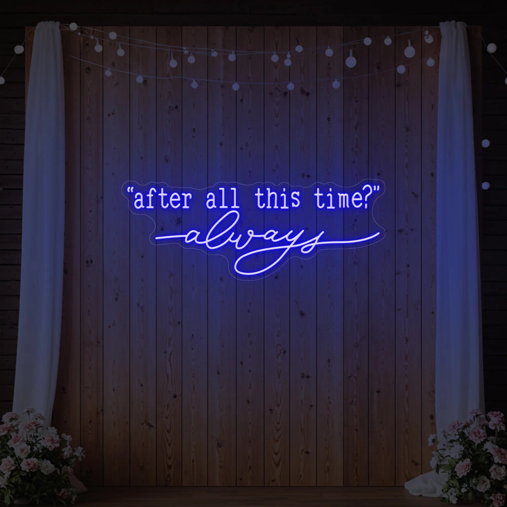 Photo of the 'After All This Time V2' neon sign glowing in deep blue against a styled interior wall.