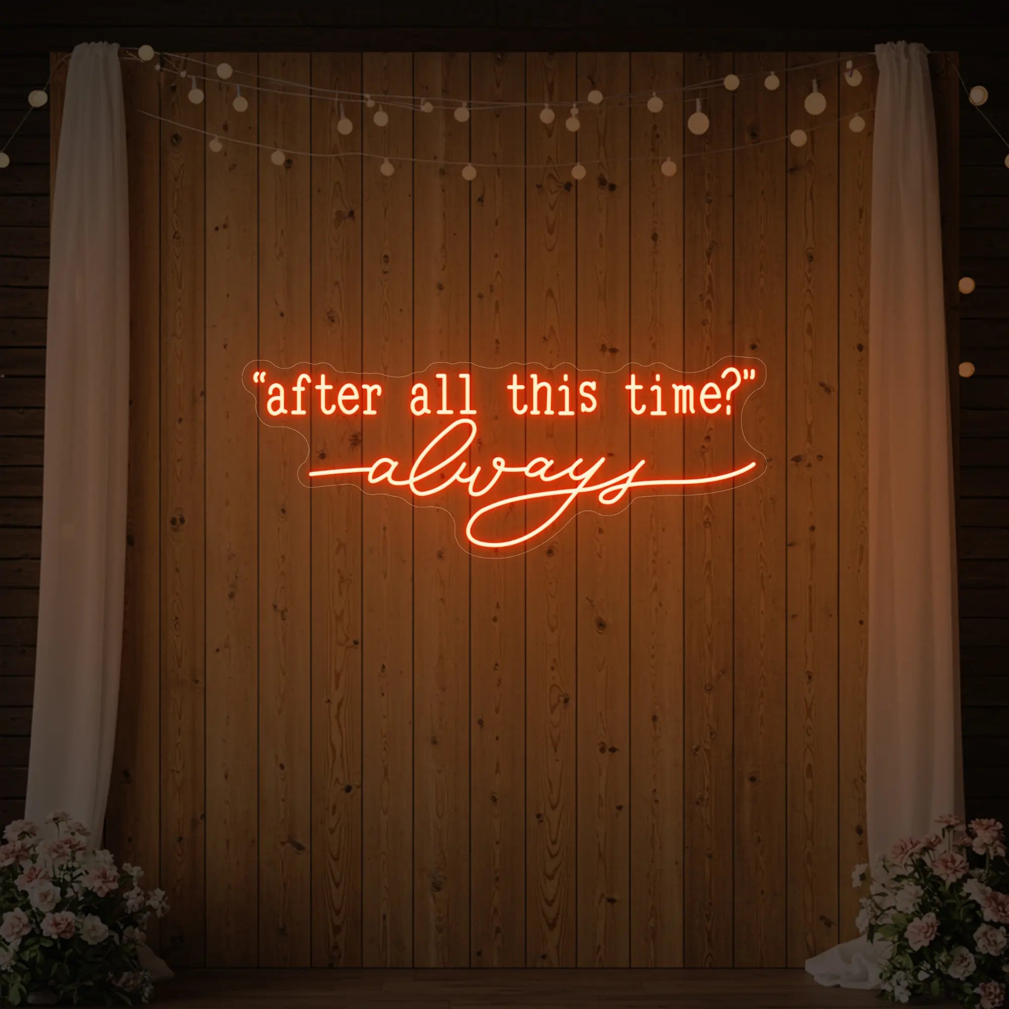 Photo of the 'After All This Time V2' neon sign glowing in golden yellow against a styled interior wall.