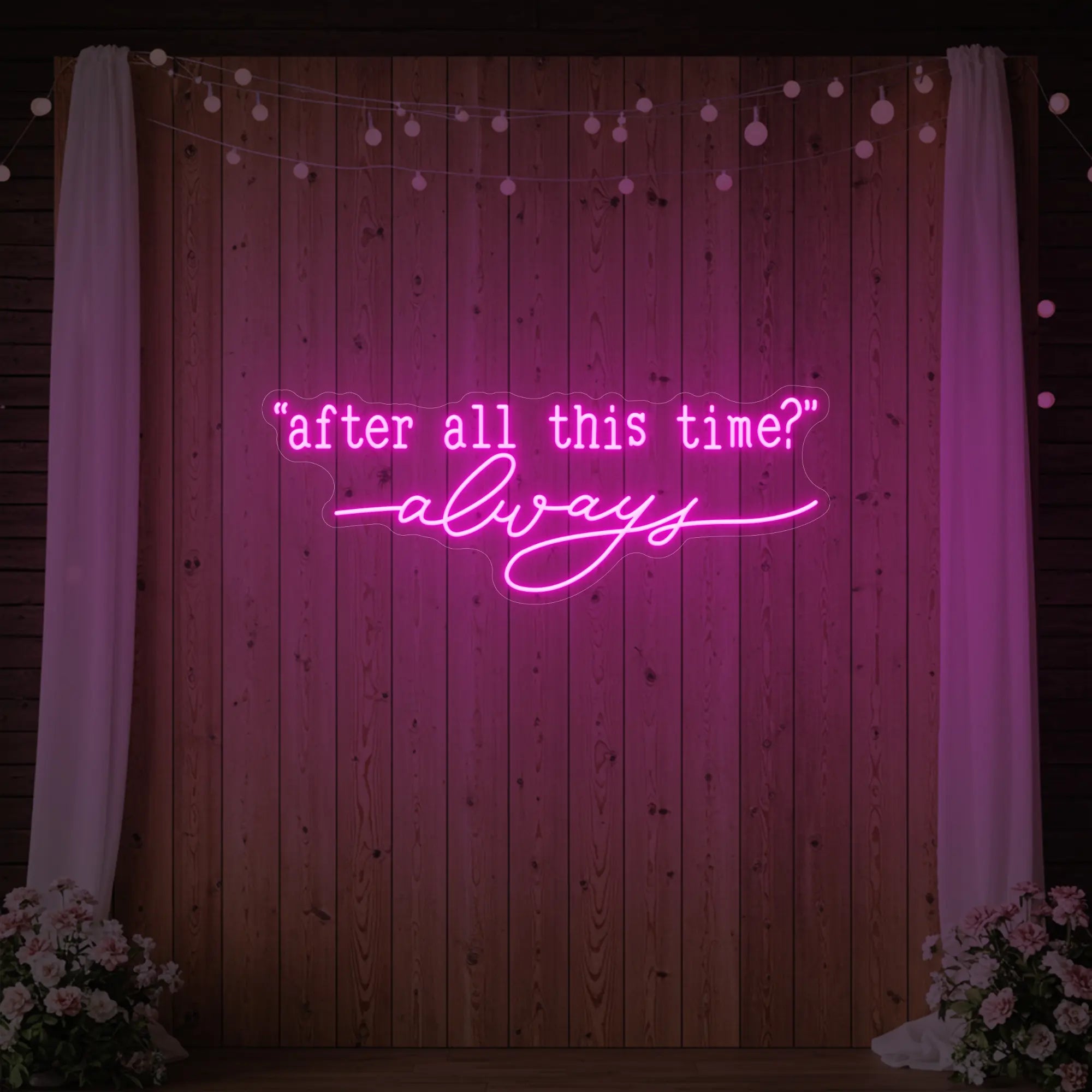 Photo of the 'After All This Time V2' neon sign glowing in light pink against a styled interior wall.