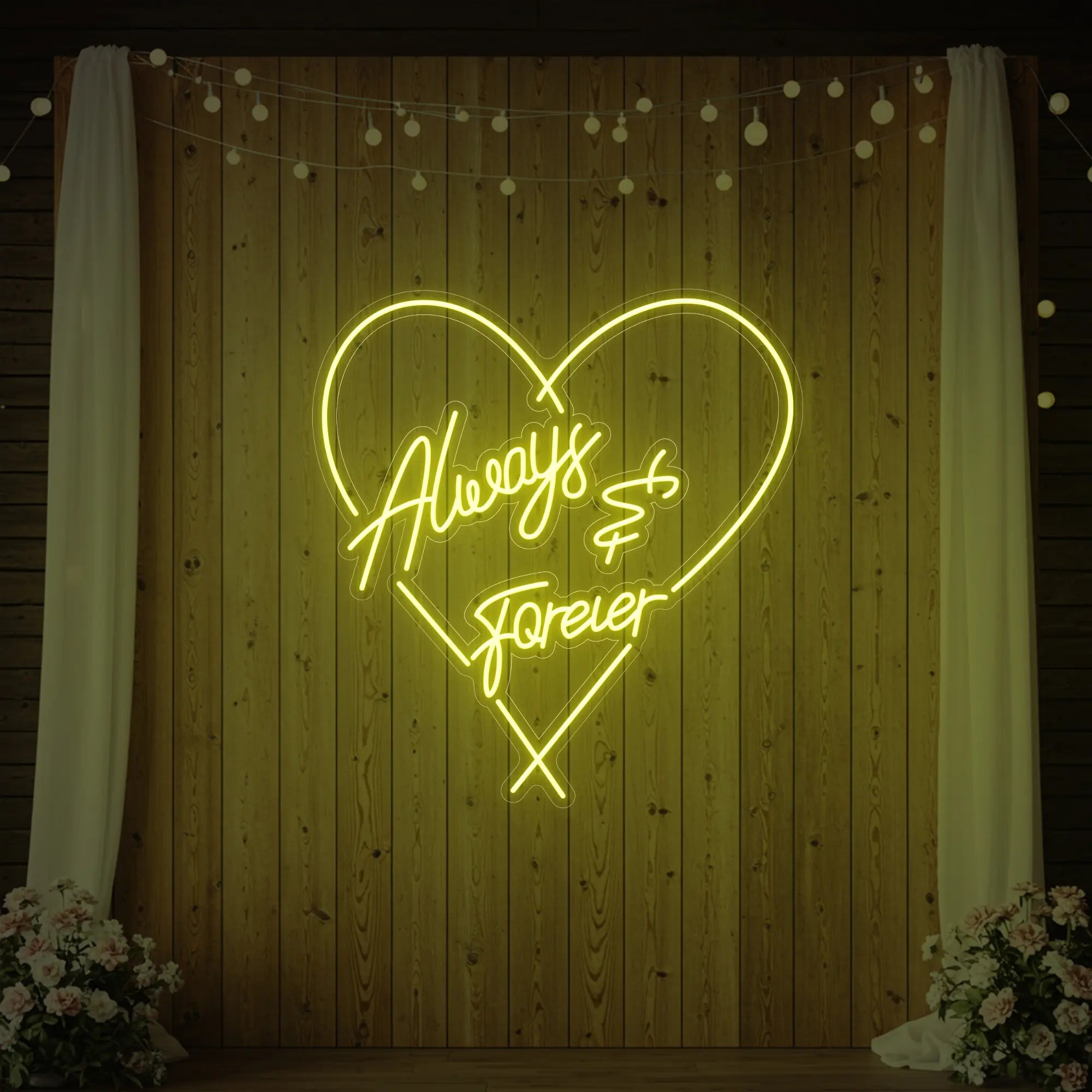 Photo of the 'Always & Forever' neon sign glowing in lemon yellow against a styled interior wall.