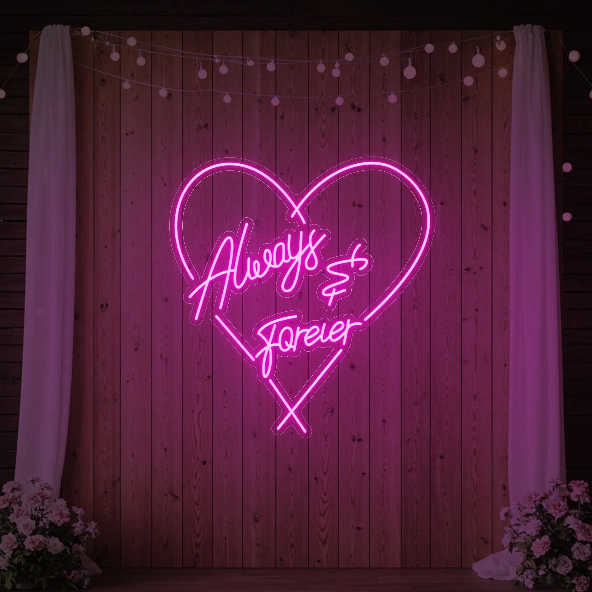 Photo of the 'Always & Forever' neon sign glowing in light pink against a styled interior wall.