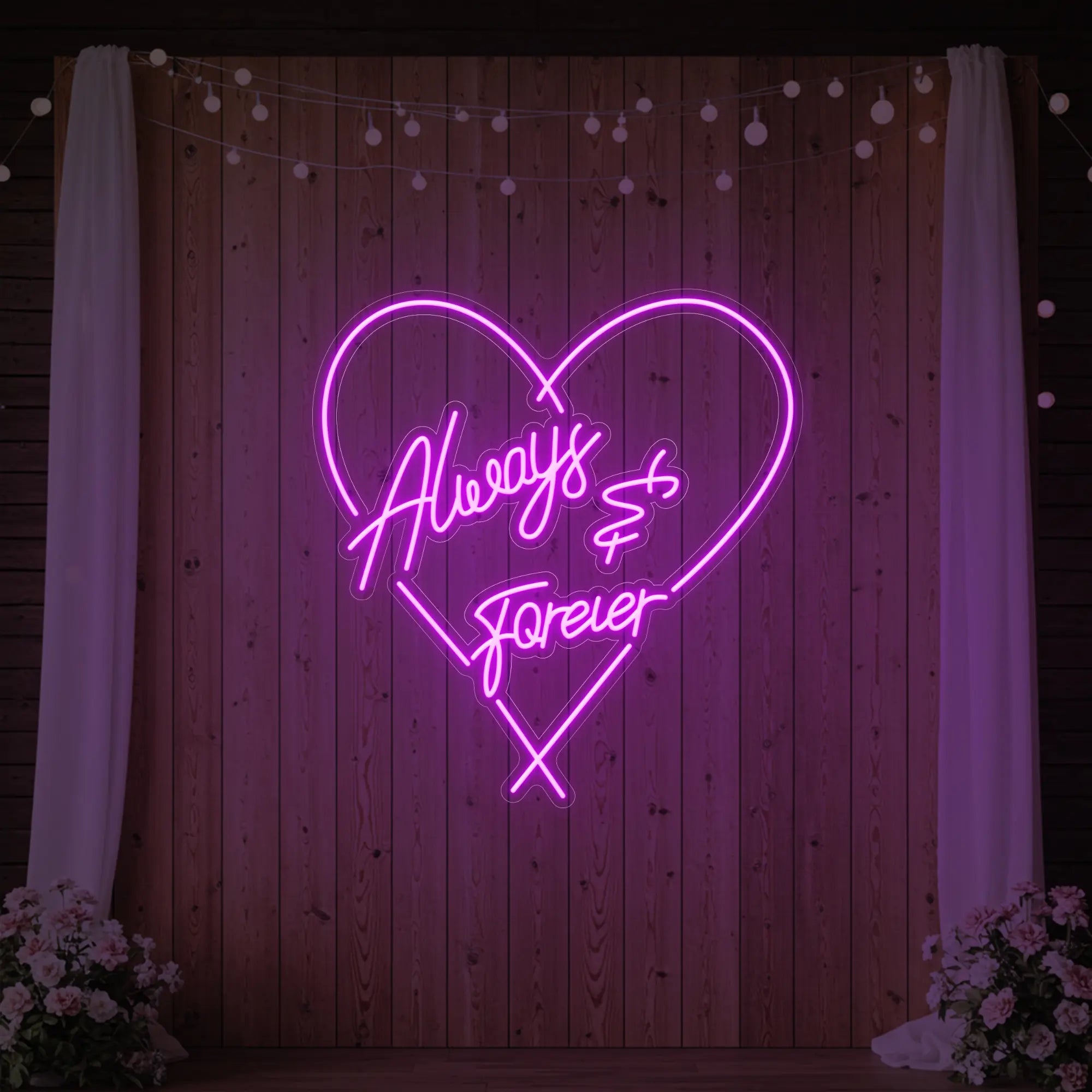 Photo of the 'Always & Forever' neon sign glowing in deep pink against a styled interior wall.