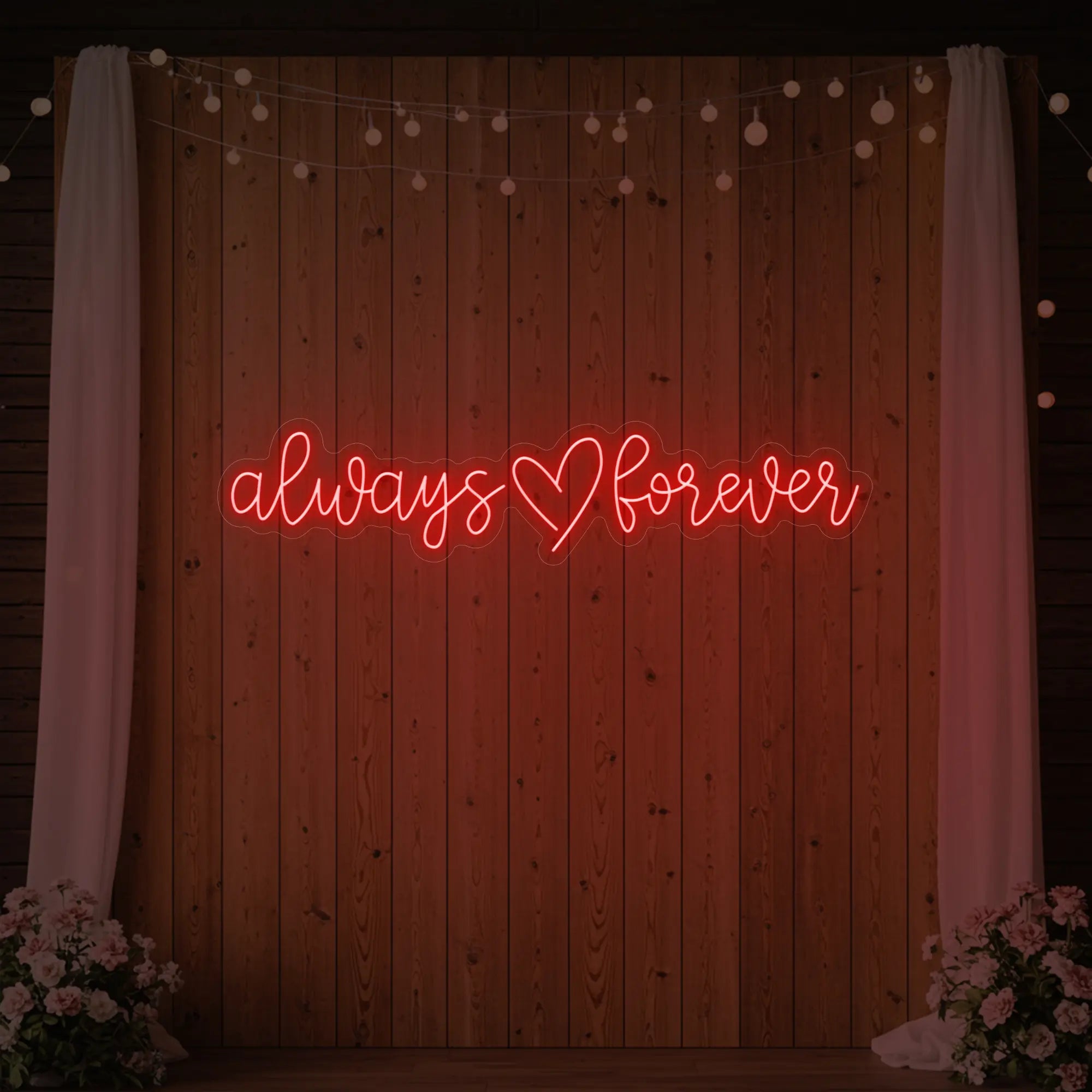 Photo of the 'Always Heart Forever' neon sign glowing in red against a styled interior wall.