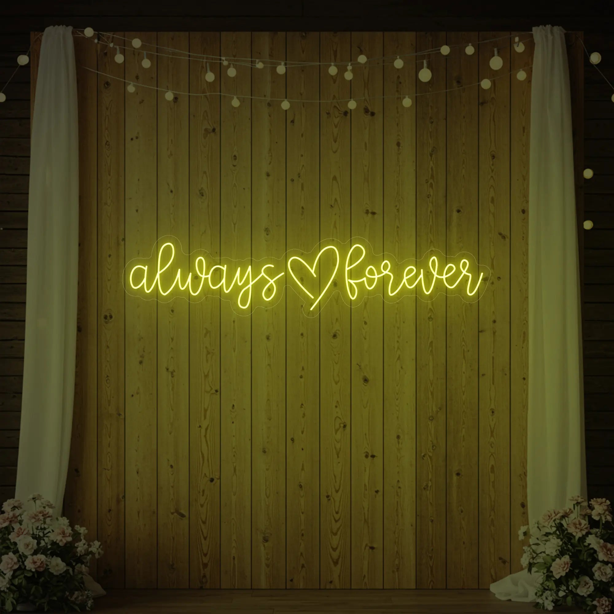 Photo of the 'Always Heart Forever' neon sign glowing in lemon yellow against a styled interior wall.
