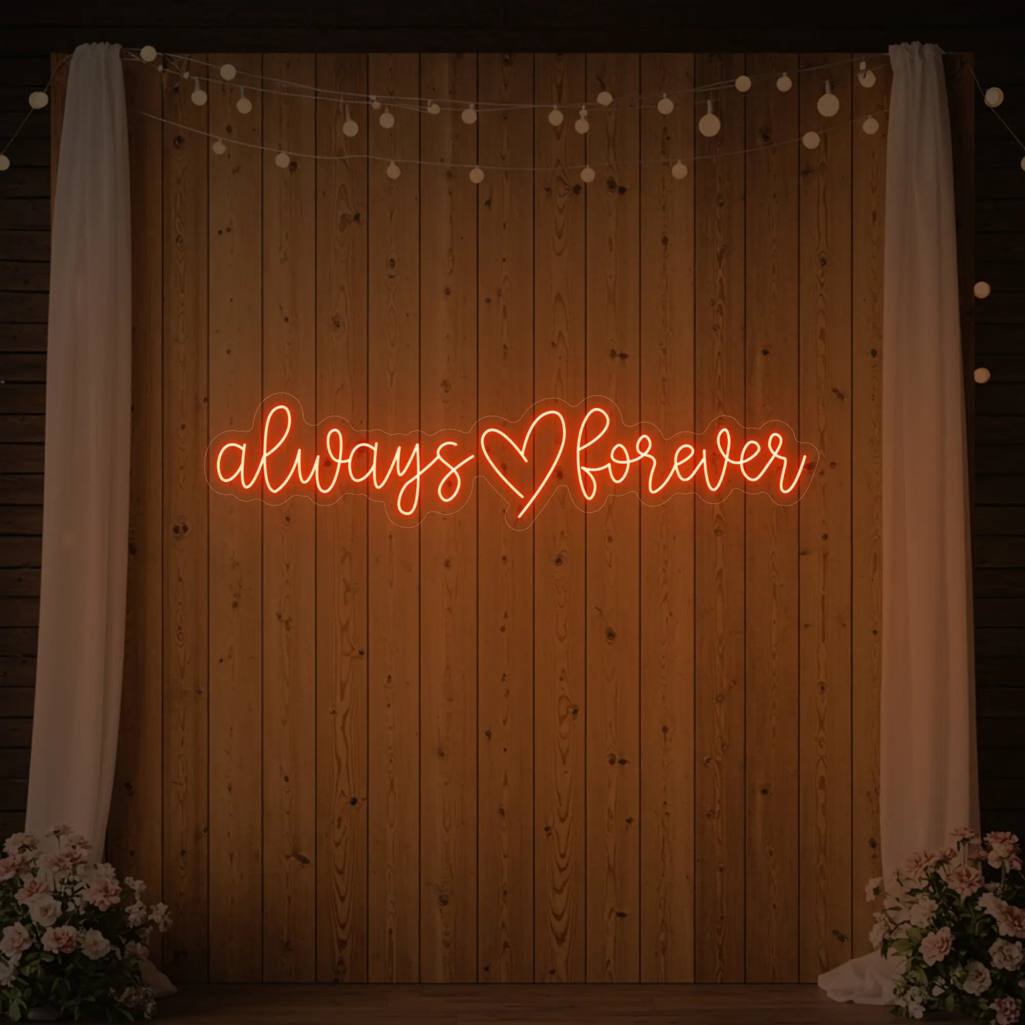 Photo of the 'Always Heart Forever' neon sign glowing in golden yellow against a styled interior wall.