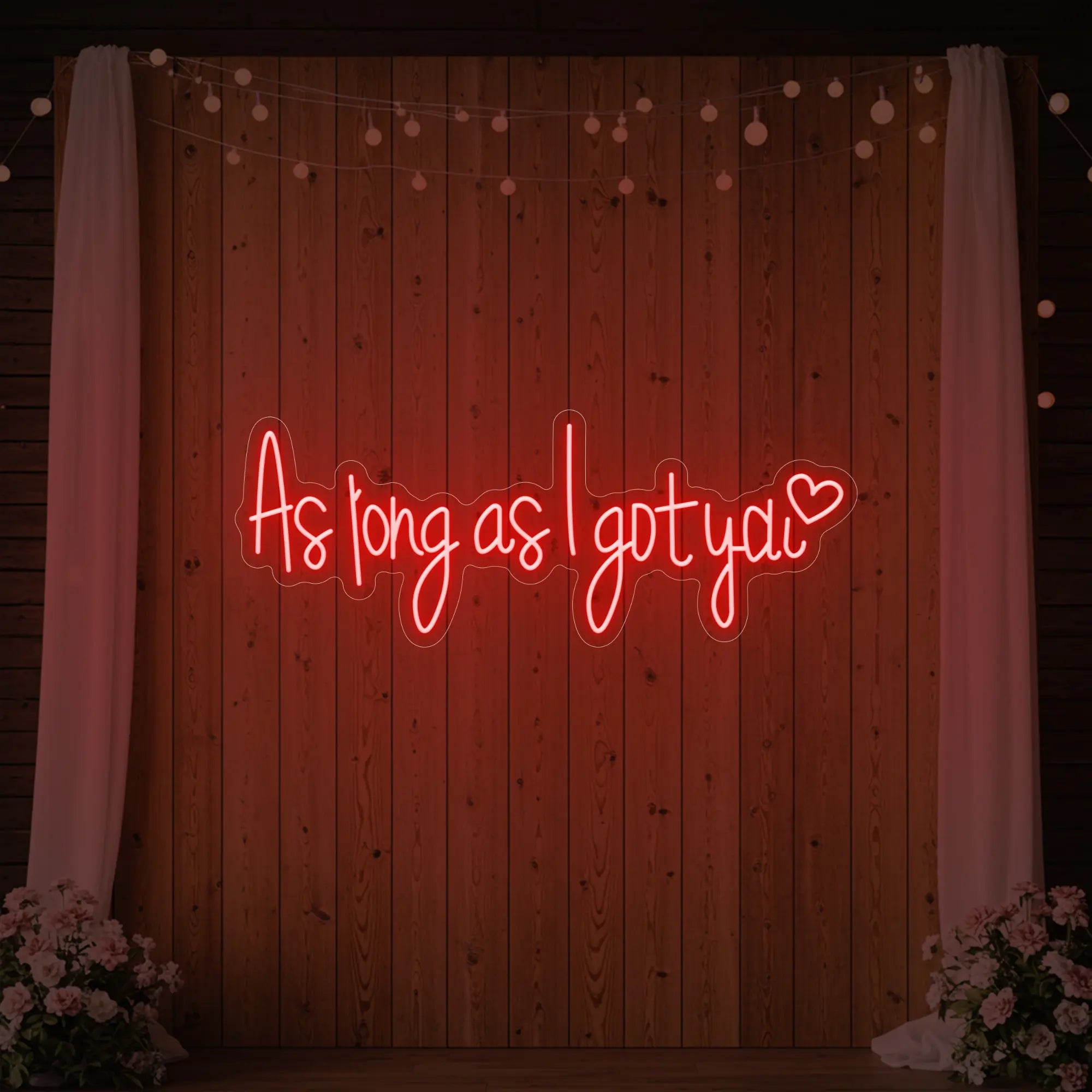 Photo of the 'As Long As I Got You' neon sign glowing in red against a styled interior wall.