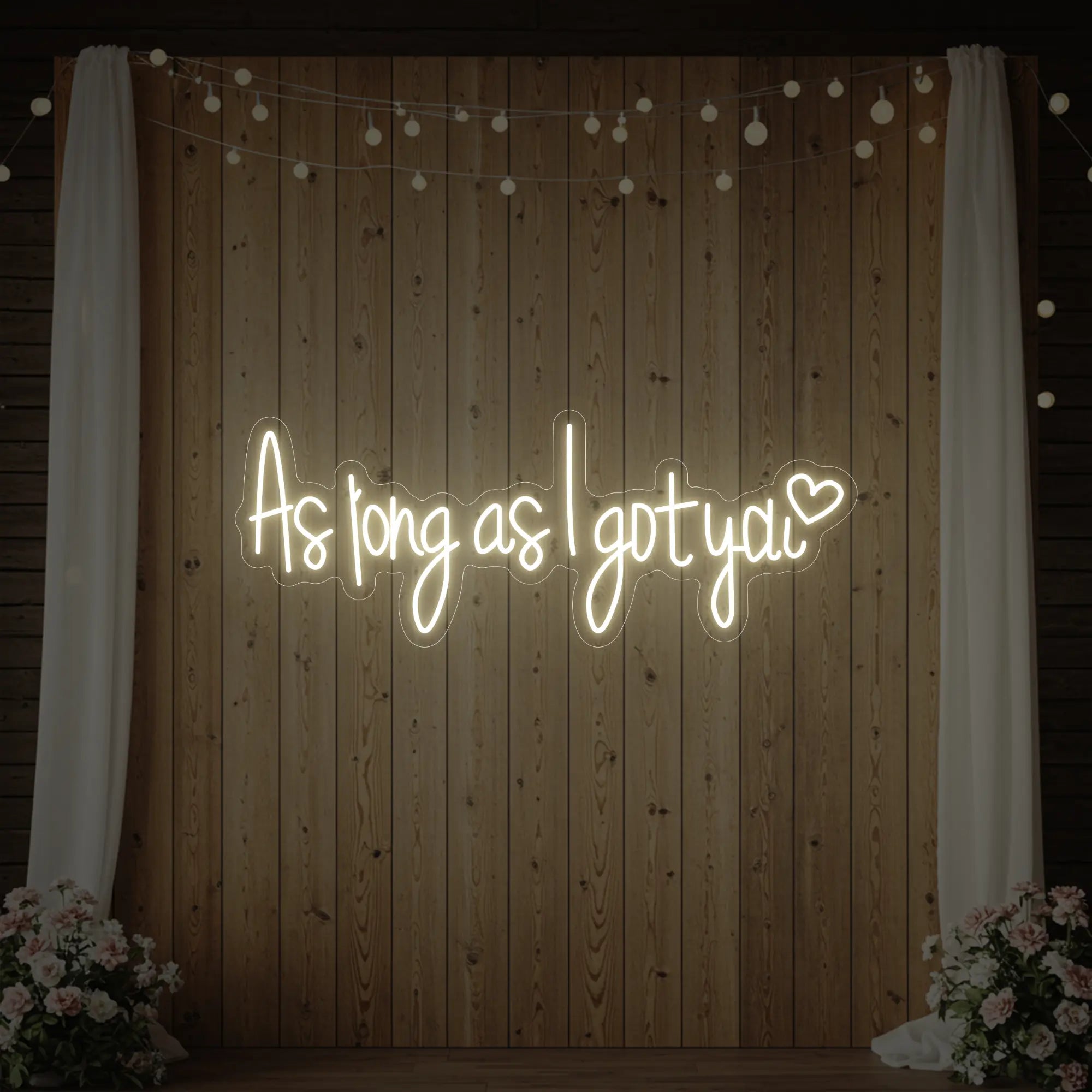 Photo of the 'As Long As I Got You' neon sign glowing in warm white against a styled interior wall.
