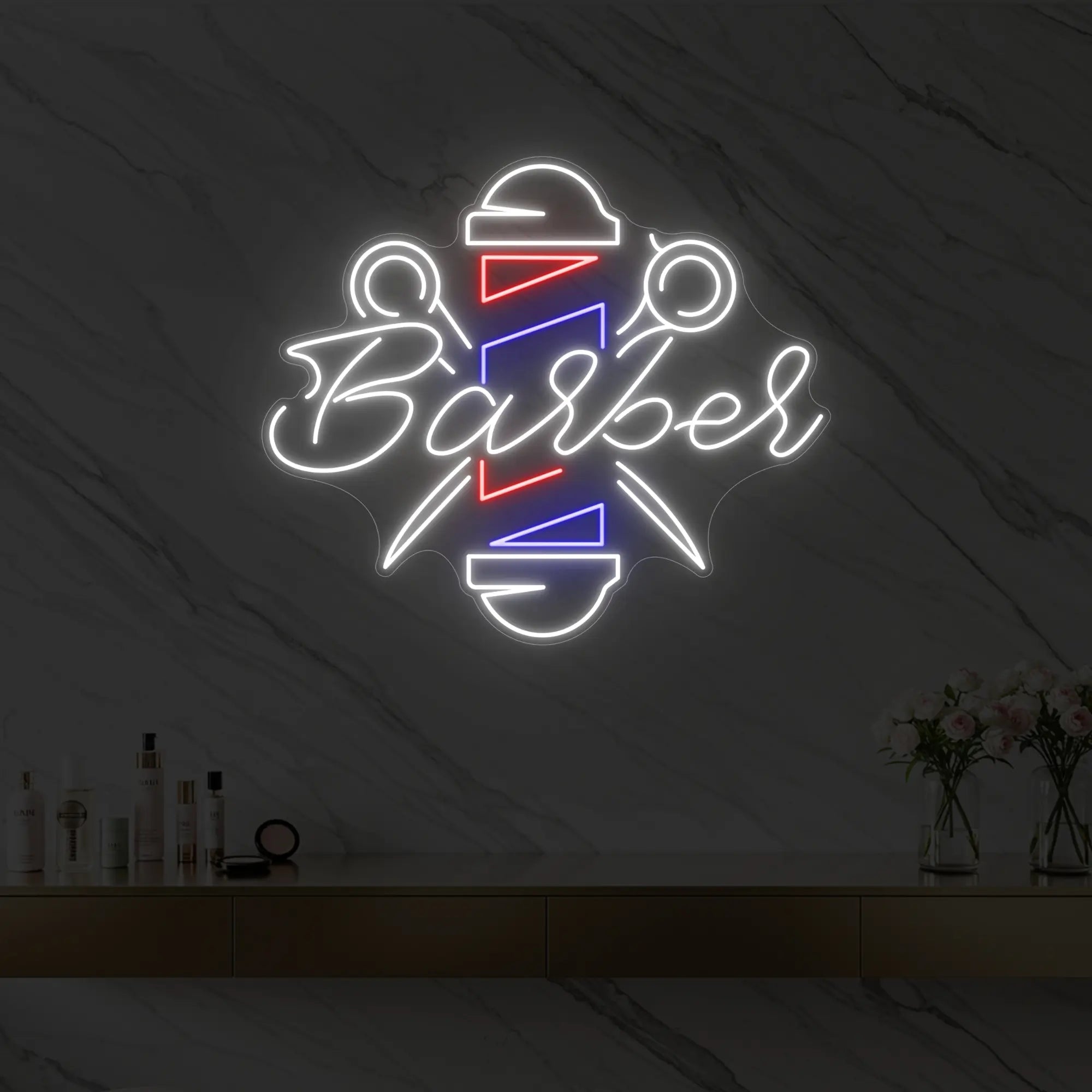 Photo of the 'Barber' neon sign glowing in cool white, red and blue against a styled interior wall.
