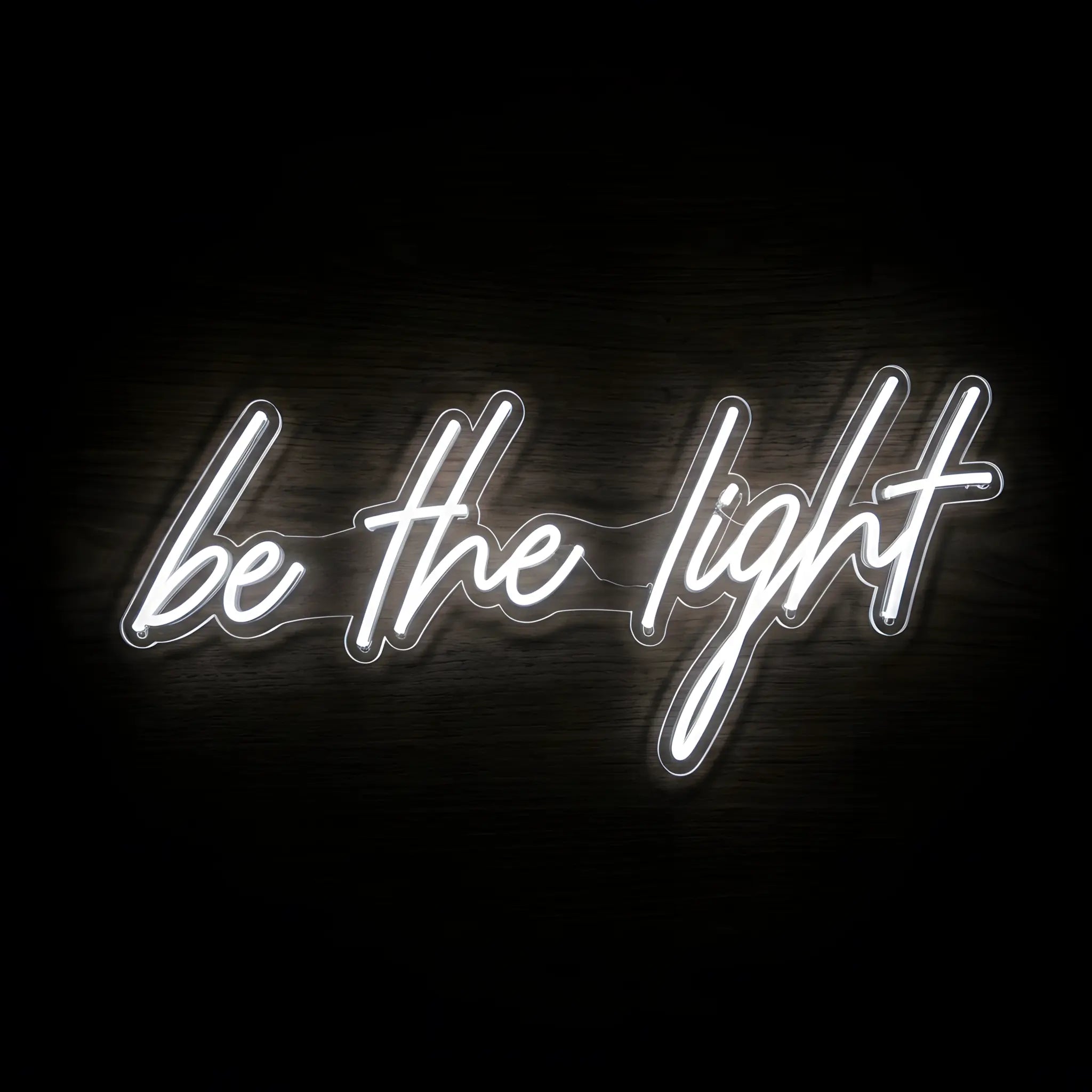 Be the Light LED neon sign with cool white illumination on precision-cut acrylic backing, Christian wall decor featuring an inspirational faith message.