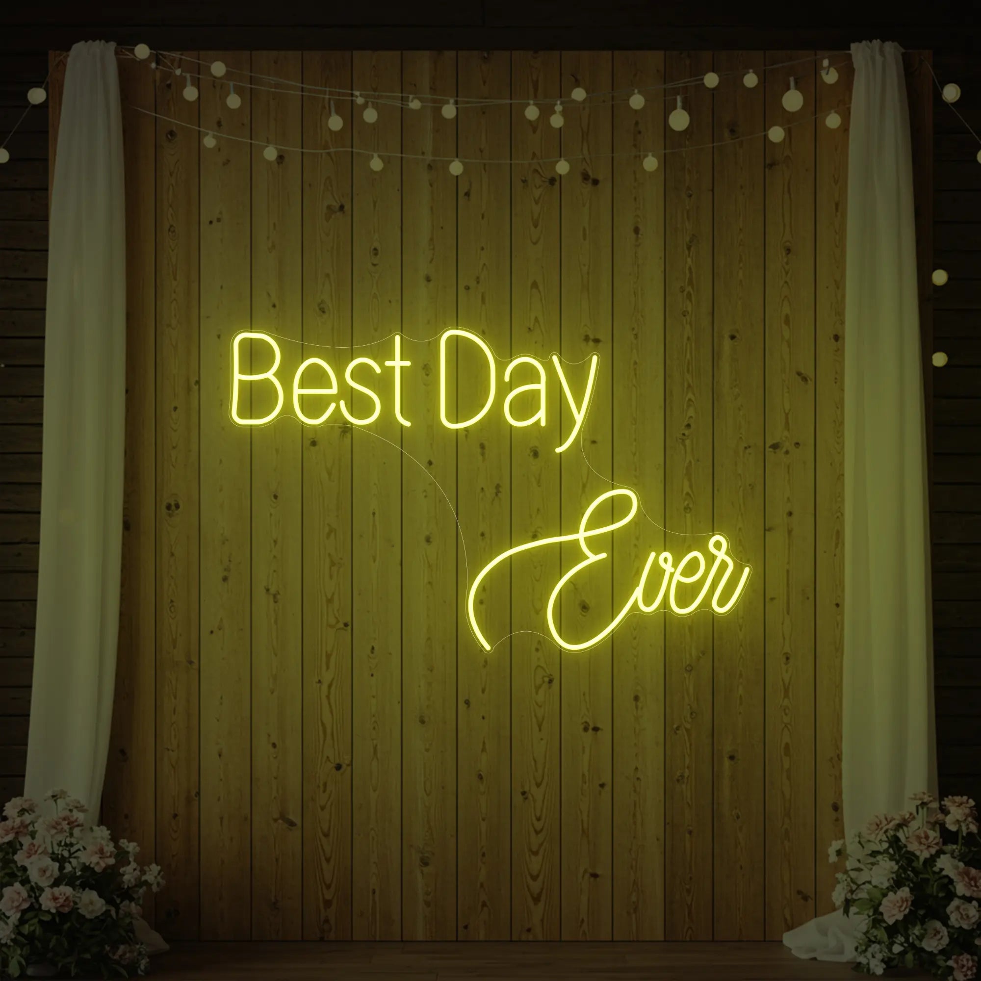 Photo of the 'Best Day Ever' neon sign glowing in lemon yellow against a styled interior wall.