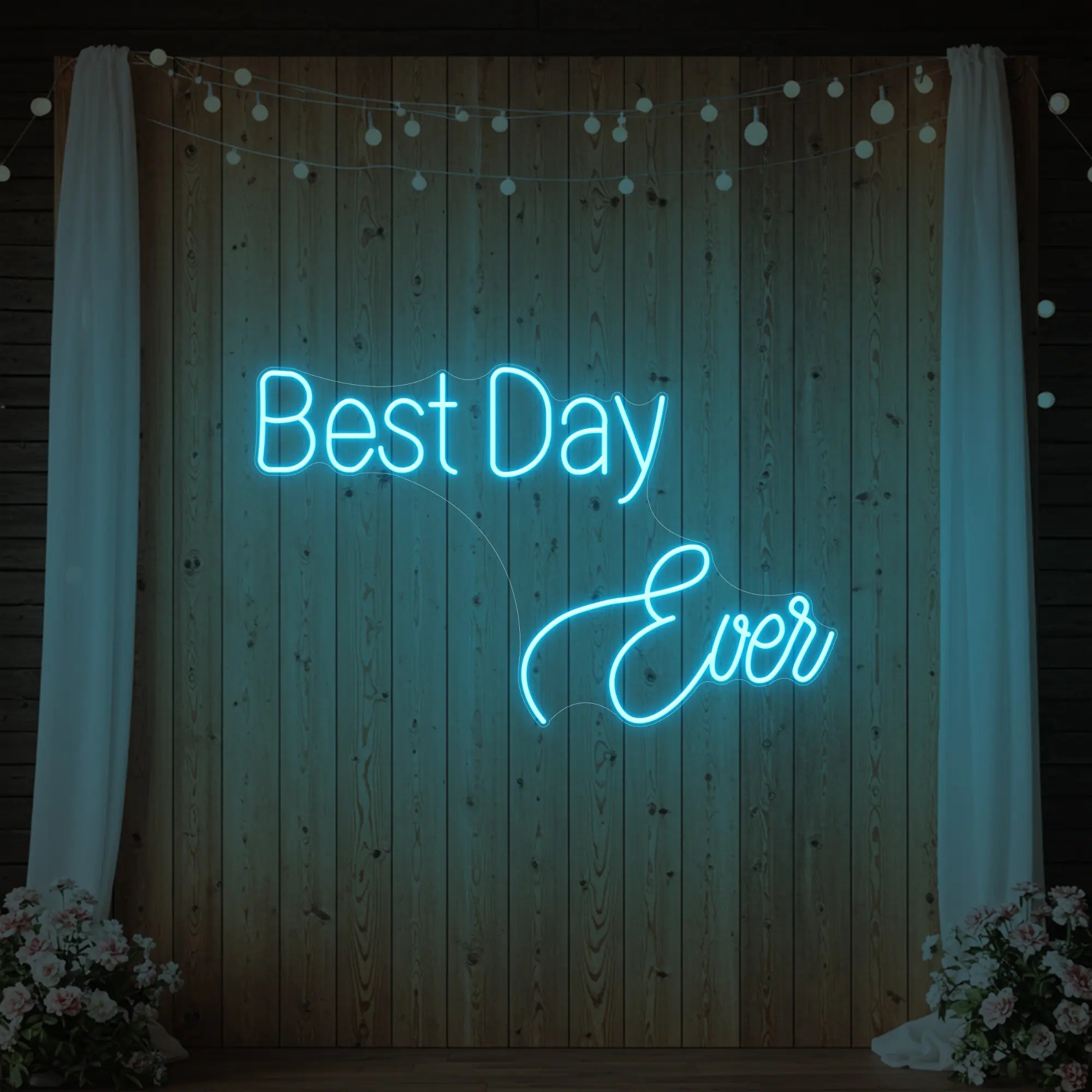 Photo of the 'Best Day Ever' neon sign glowing in ice blue against a styled interior wall.