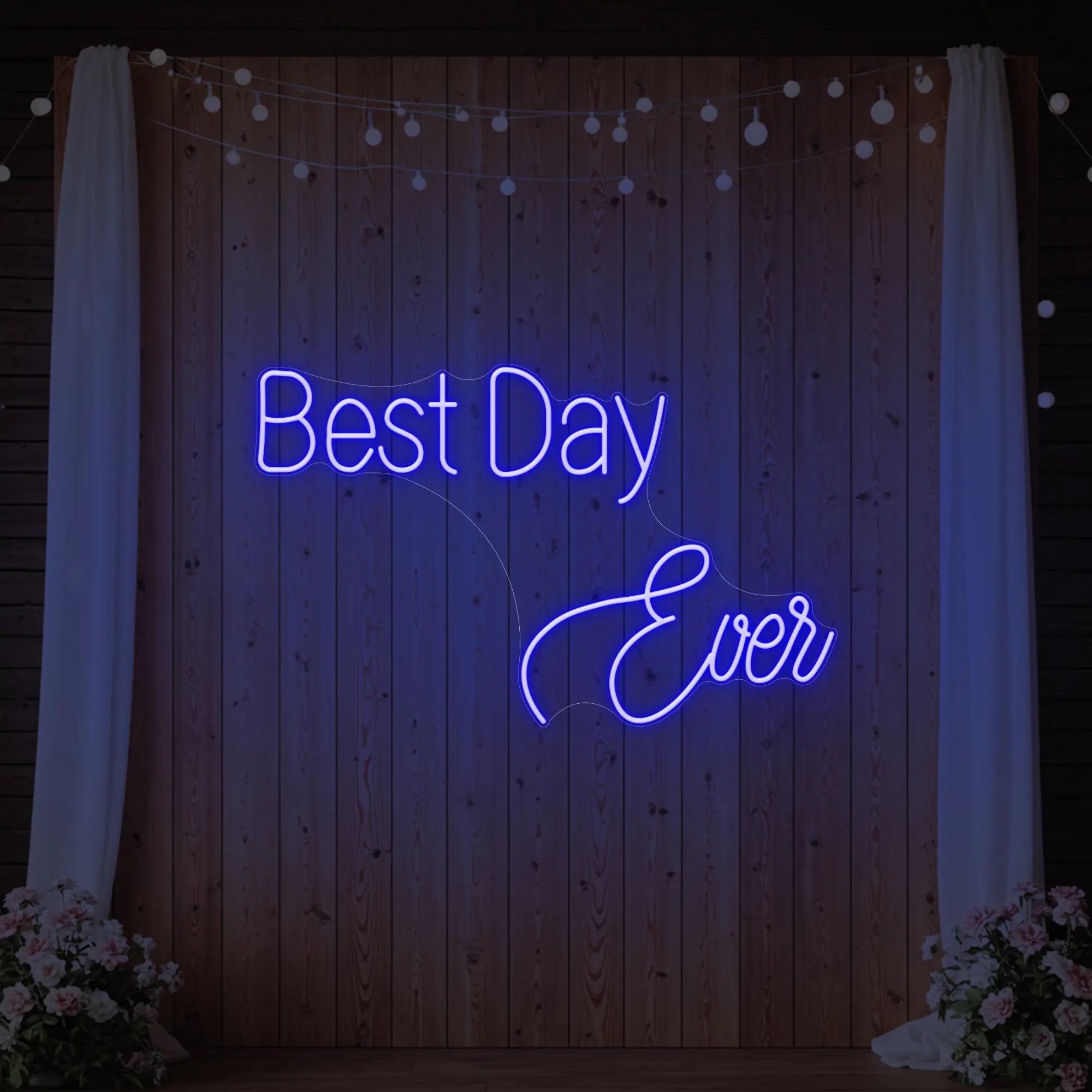 Photo of the 'Best Day Ever' neon sign glowing in deep blue against a styled interior wall.