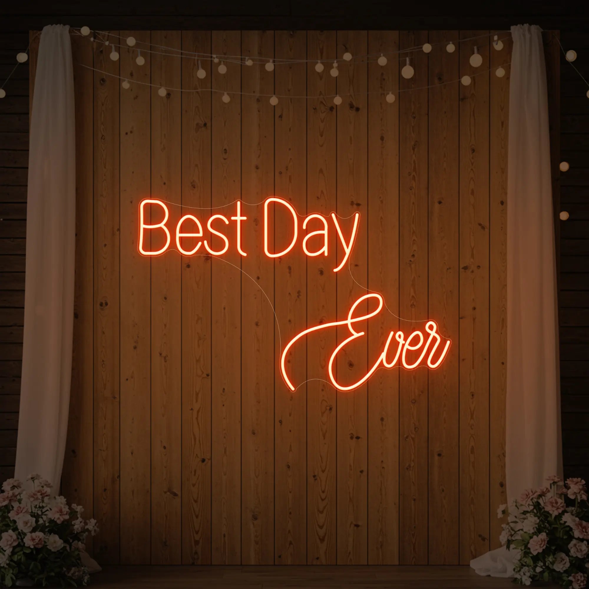 Photo of the 'Best Day Ever' neon sign glowing in golden yellow against a styled interior wall.
