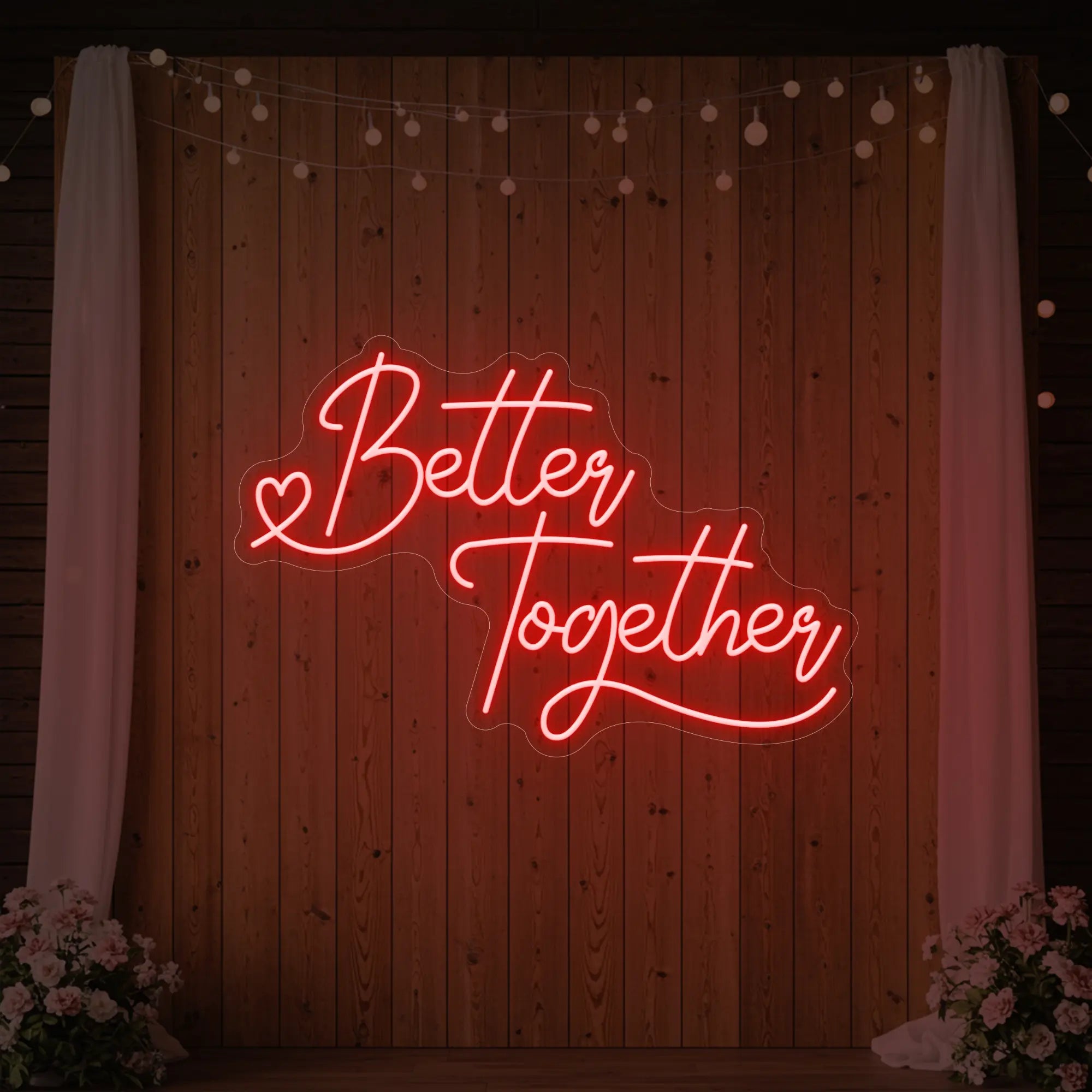 Photo of the 'Better Together' neon sign glowing in red against a styled interior wall.
