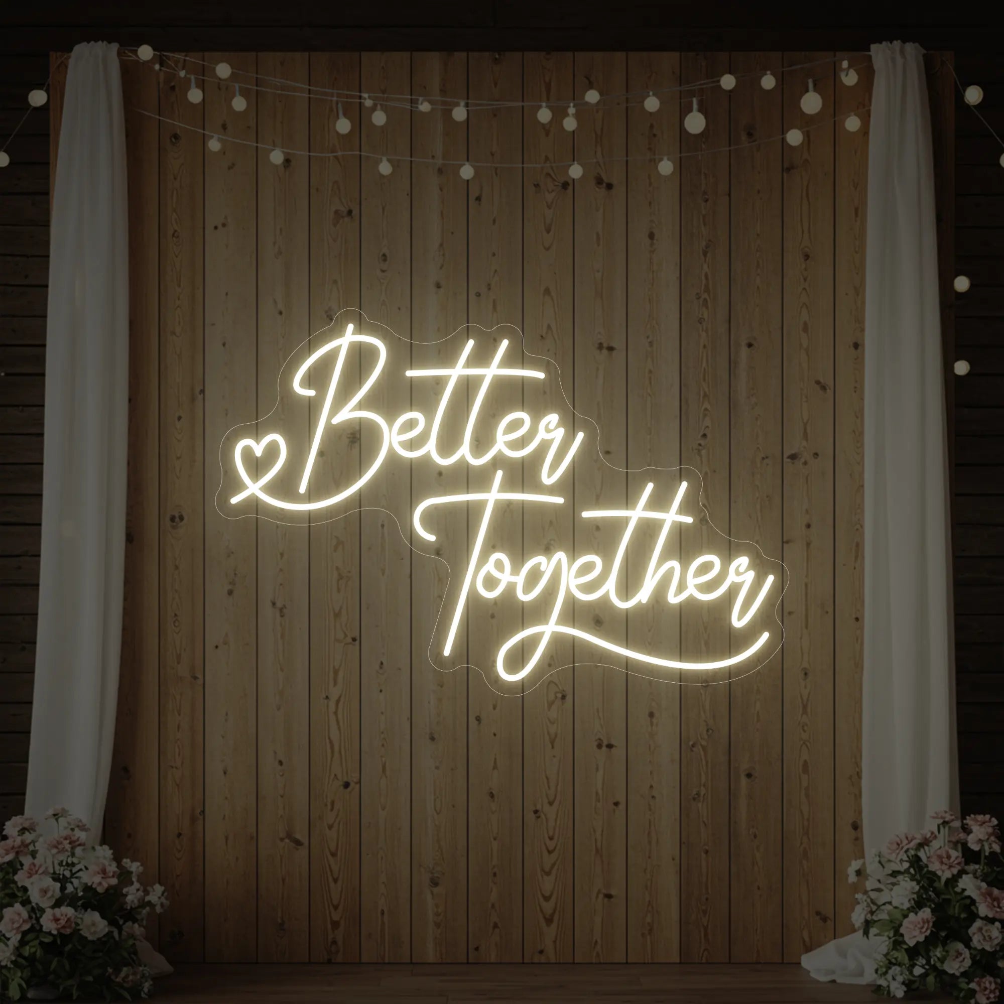 Photo of the 'Better Together' neon sign glowing in warm white against a styled interior wall.