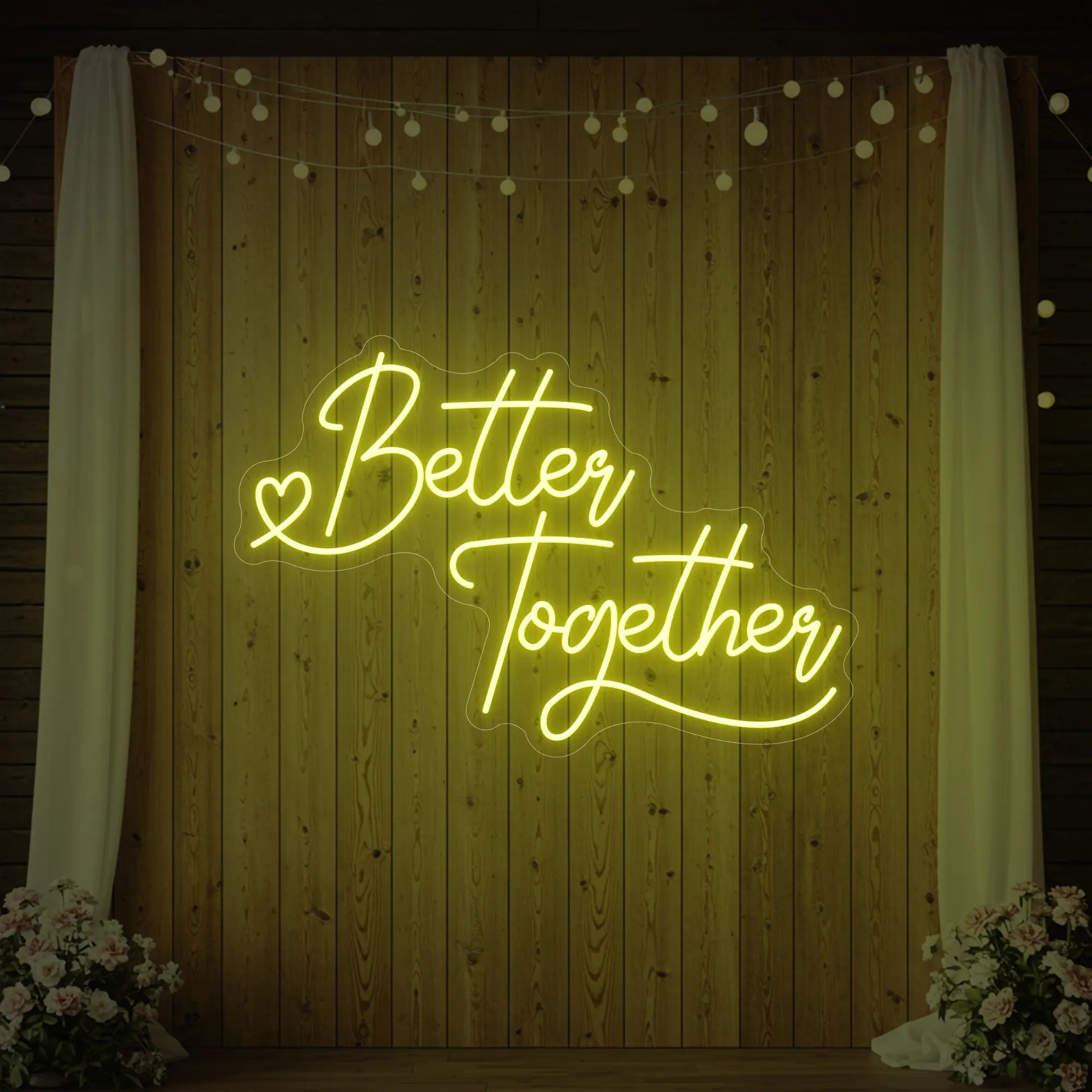 Photo of the 'Better Together' neon sign glowing in lemon yellow against a styled interior wall.