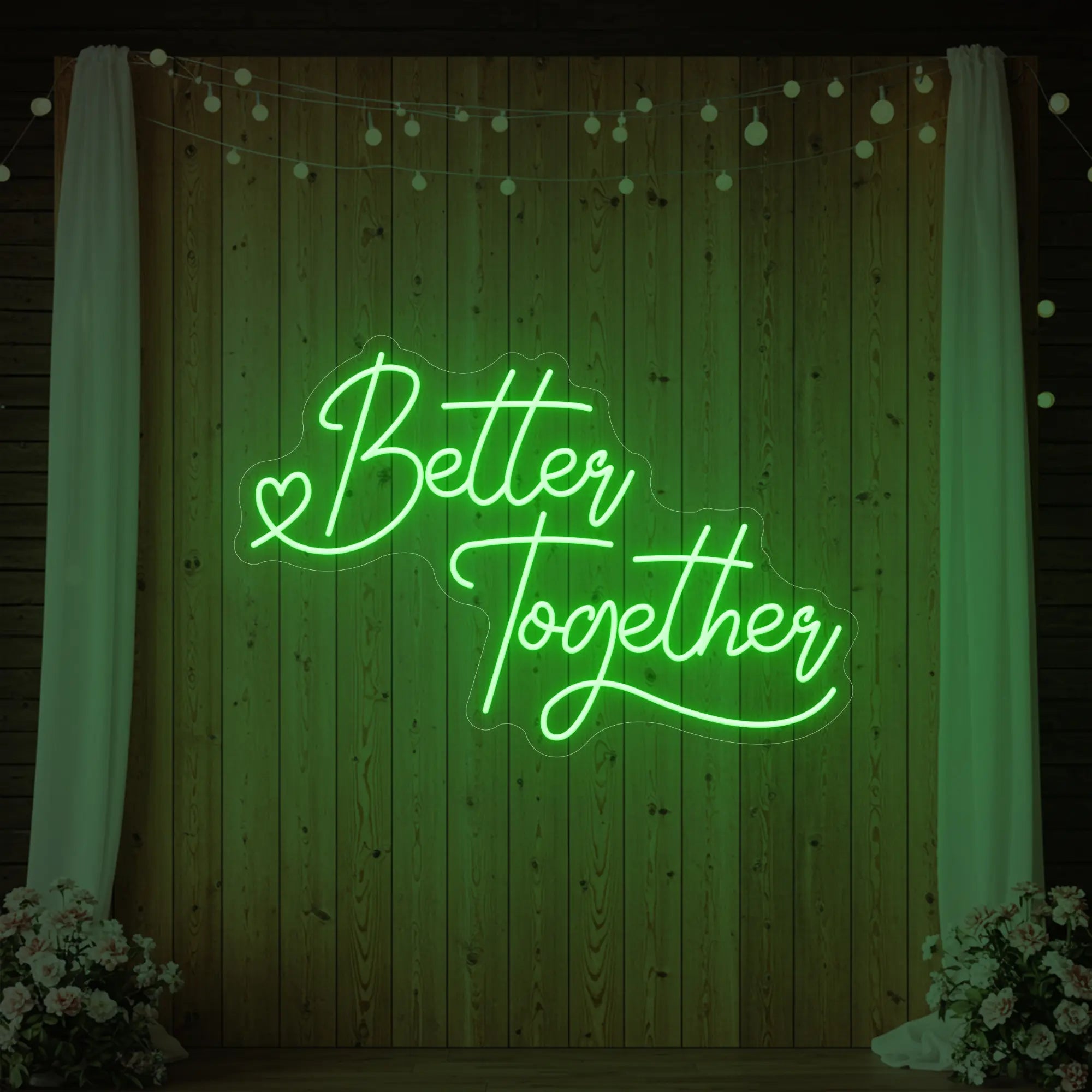 Photo of the 'Better Together' neon sign glowing in green against a styled interior wall.