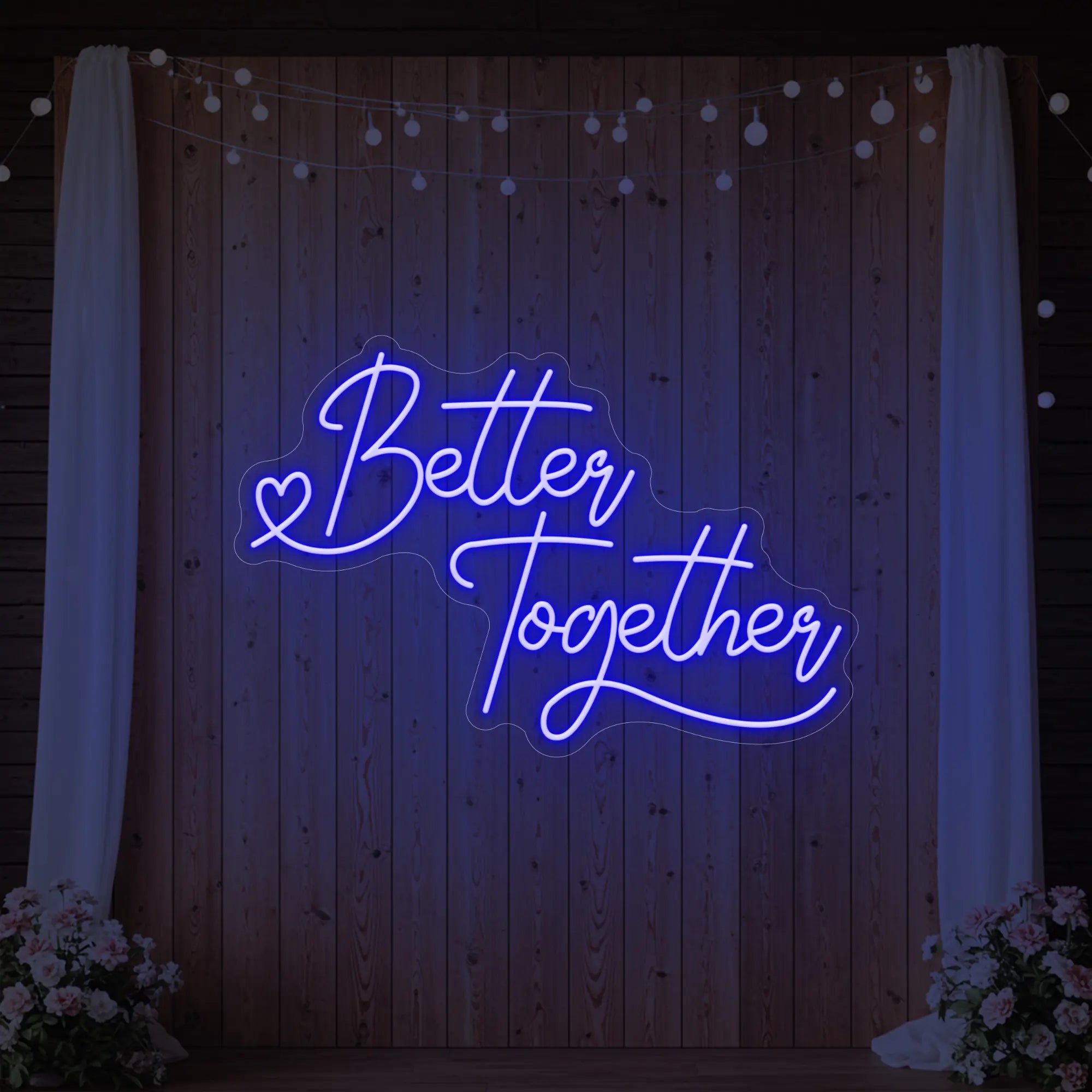 Photo of the 'Better Together' neon sign glowing in deep blue against a styled interior wall.