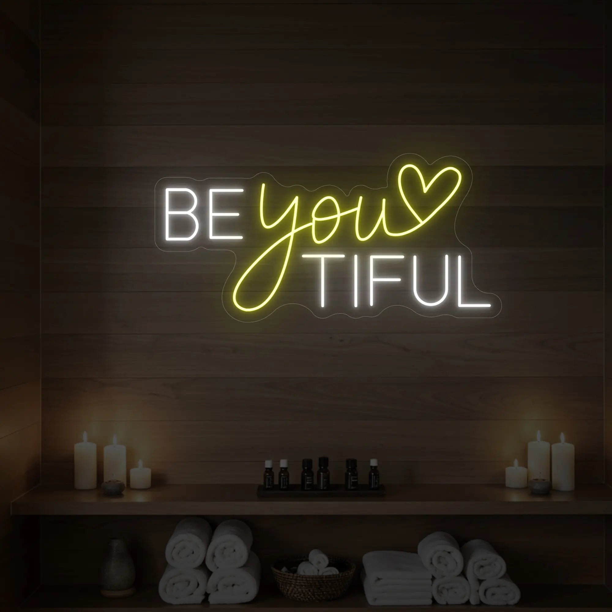 Photo of the 'BEYOUtiful' neon sign glowing in lemon yellow against a styled interior wall.