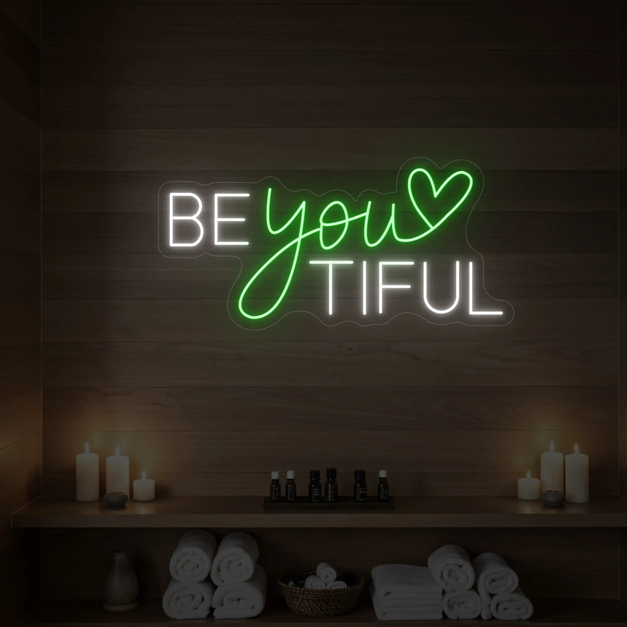 Photo of the 'BEYOUtiful' neon sign glowing in green against a styled interior wall.