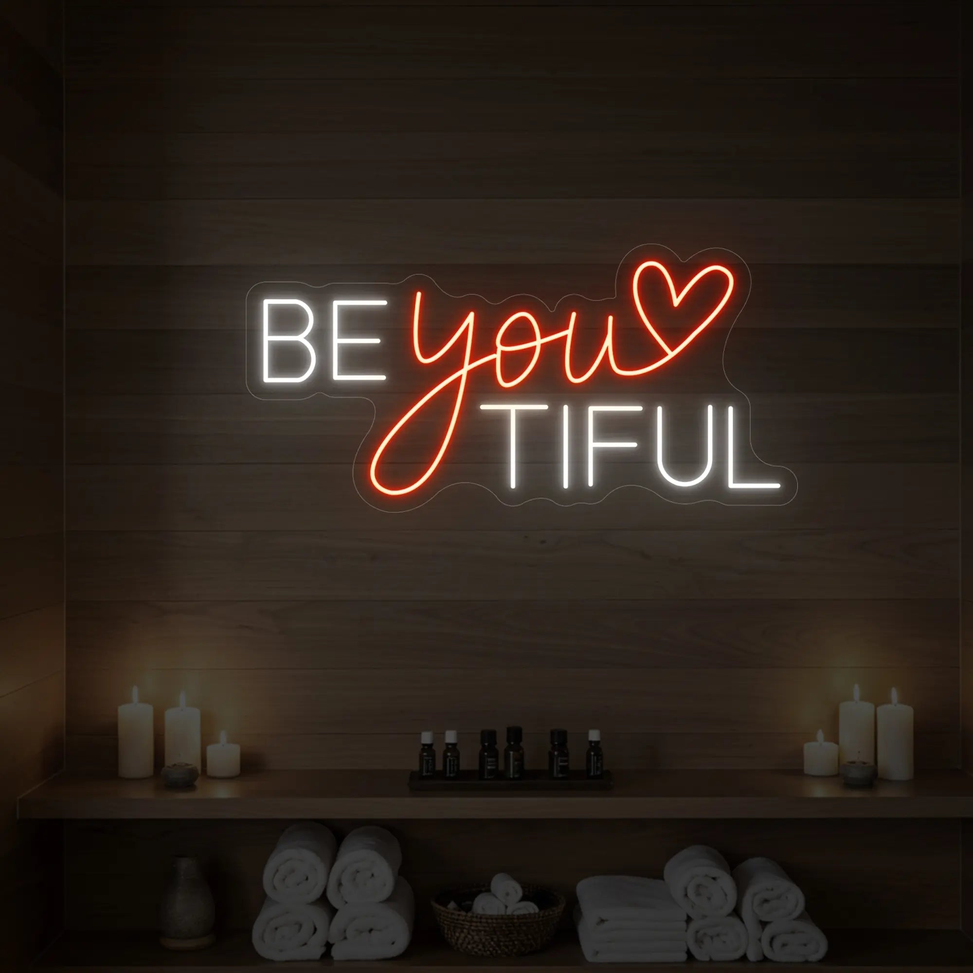 Photo of the 'BEYOUtiful' neon sign glowing in golden yellow against a styled interior wall.