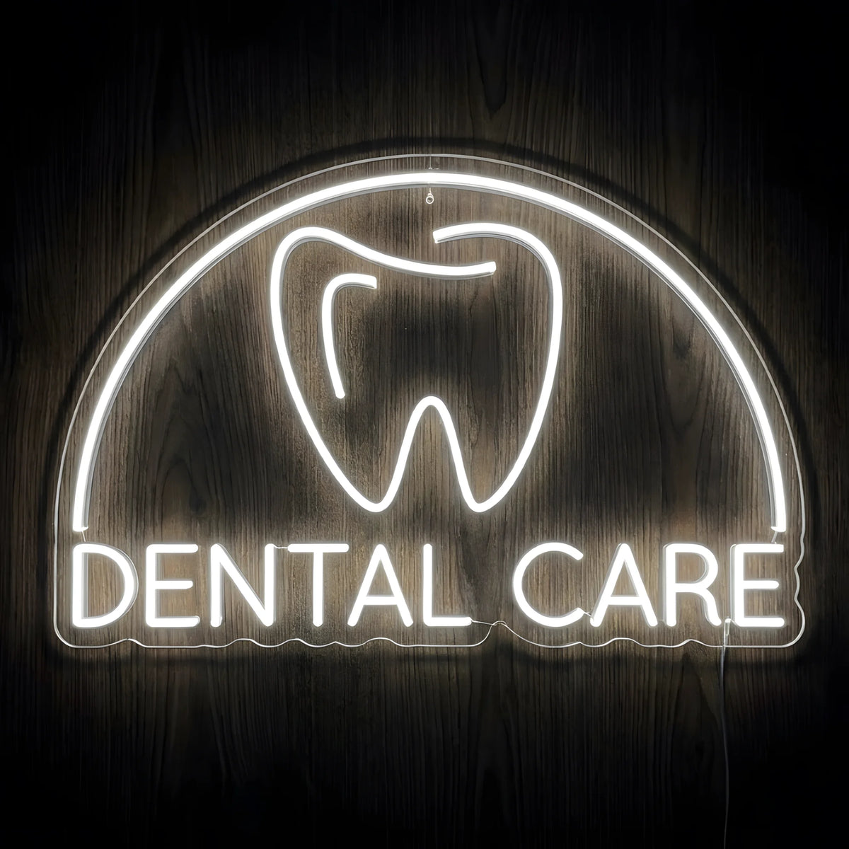 Classic Dental Care Emblem LED Neon Sign featuring a glowing white tooth icon, curved arch, and DENTAL CARE lettering on clear acrylic backing against a dark wooden wall.