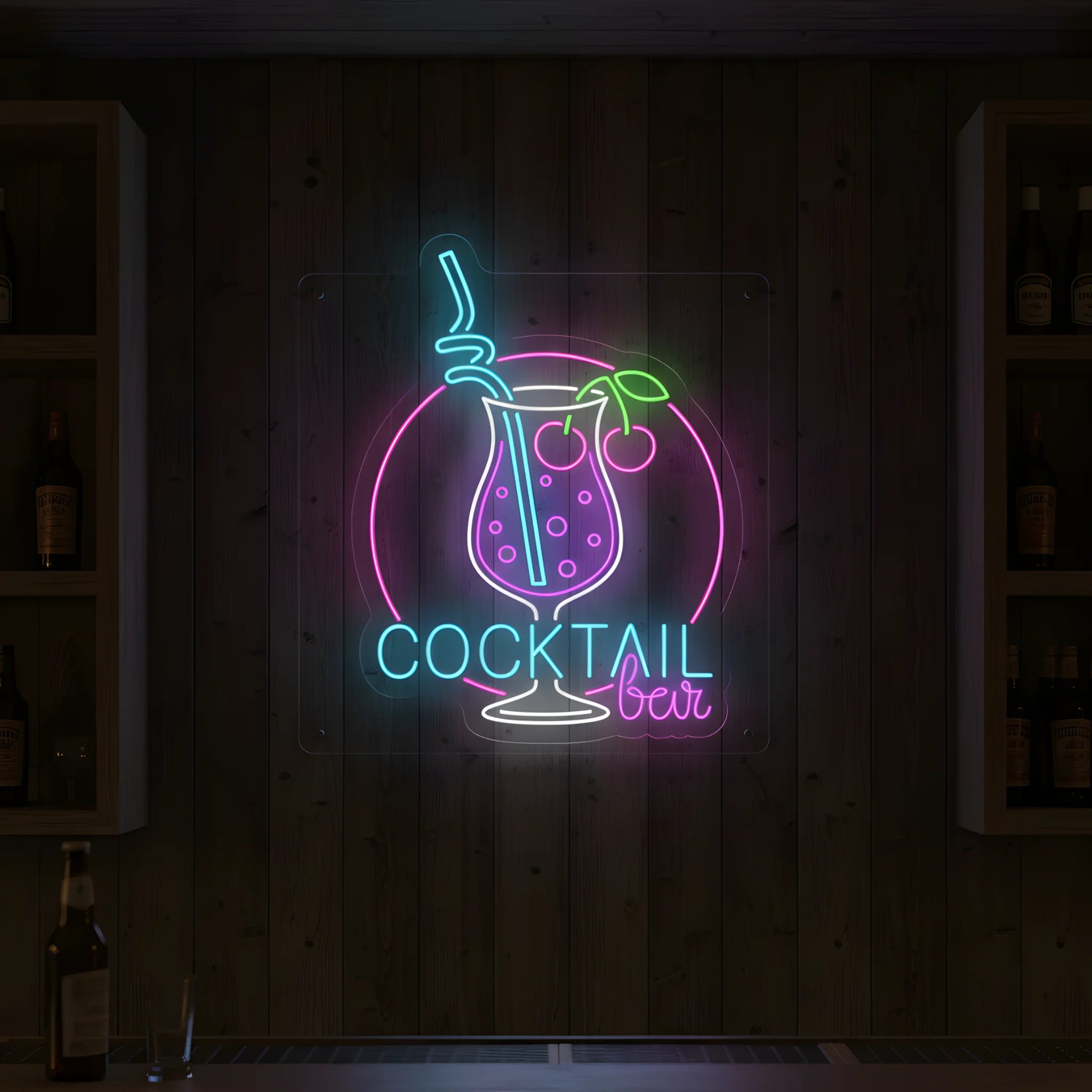 Photo of the 'COCKTAIL BAR' neon sign glowing in multi-color against a styled interior wall.