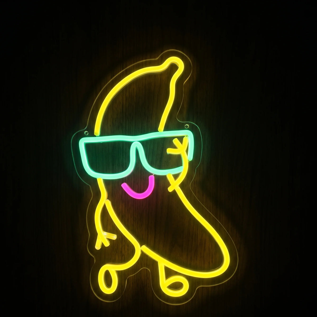 Cool banana LED neon sign with yellow banana character, aqua sunglasses, pink smile, and clear acrylic backing.
