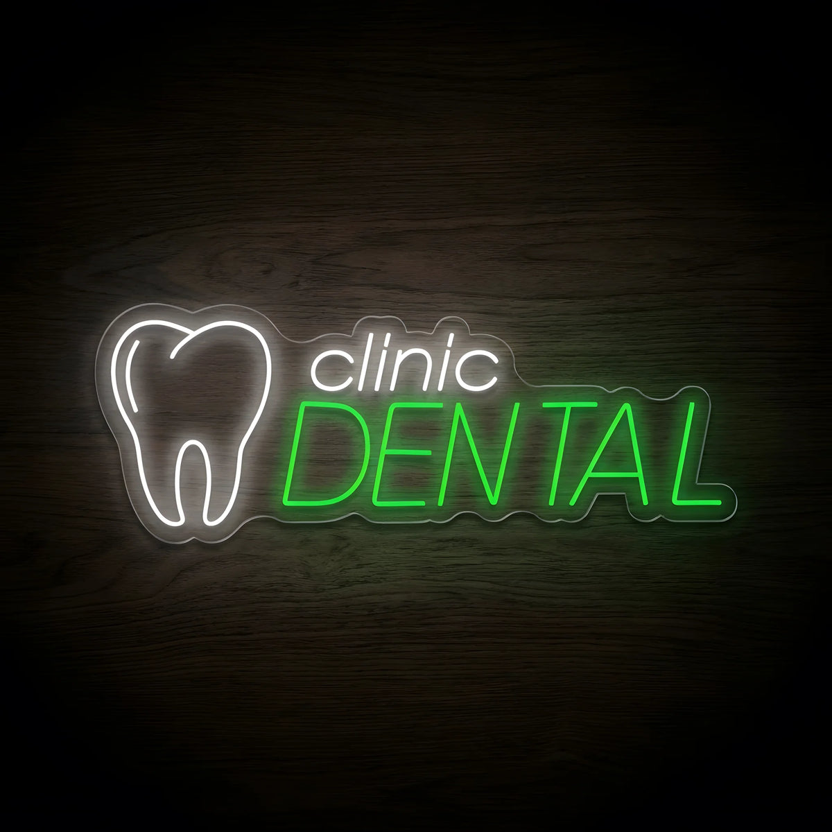 Dental Clinic Logo LED neon sign featuring a glowing white tooth outline, white clinic lettering, and vibrant green DENTAL text on clear acrylic backing, displayed against a dark wooden wall.
