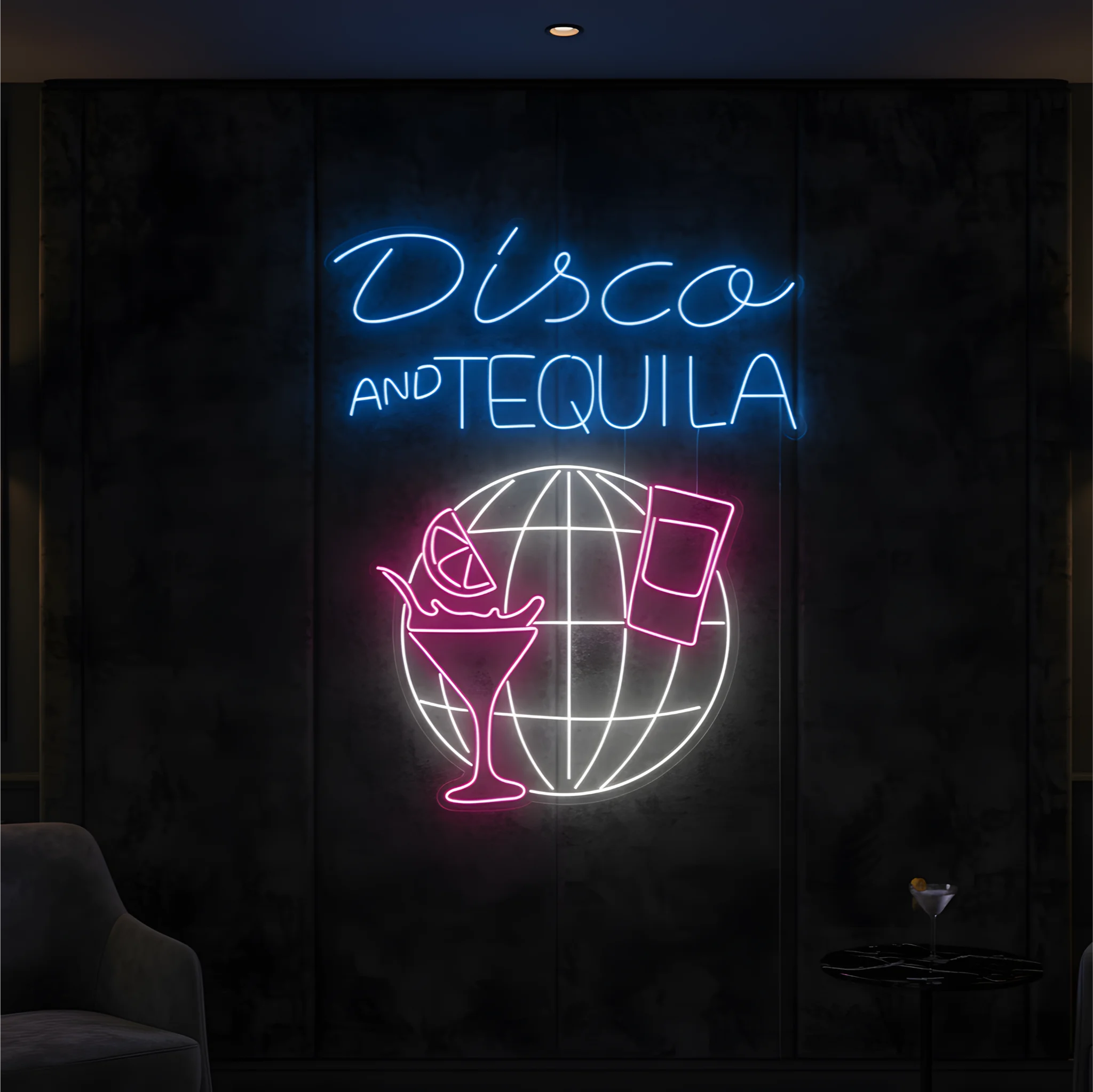 Photo of the 'Disco & Tequila' neon sign glowing in multi-color against a stylish nightlife-inspired wall.