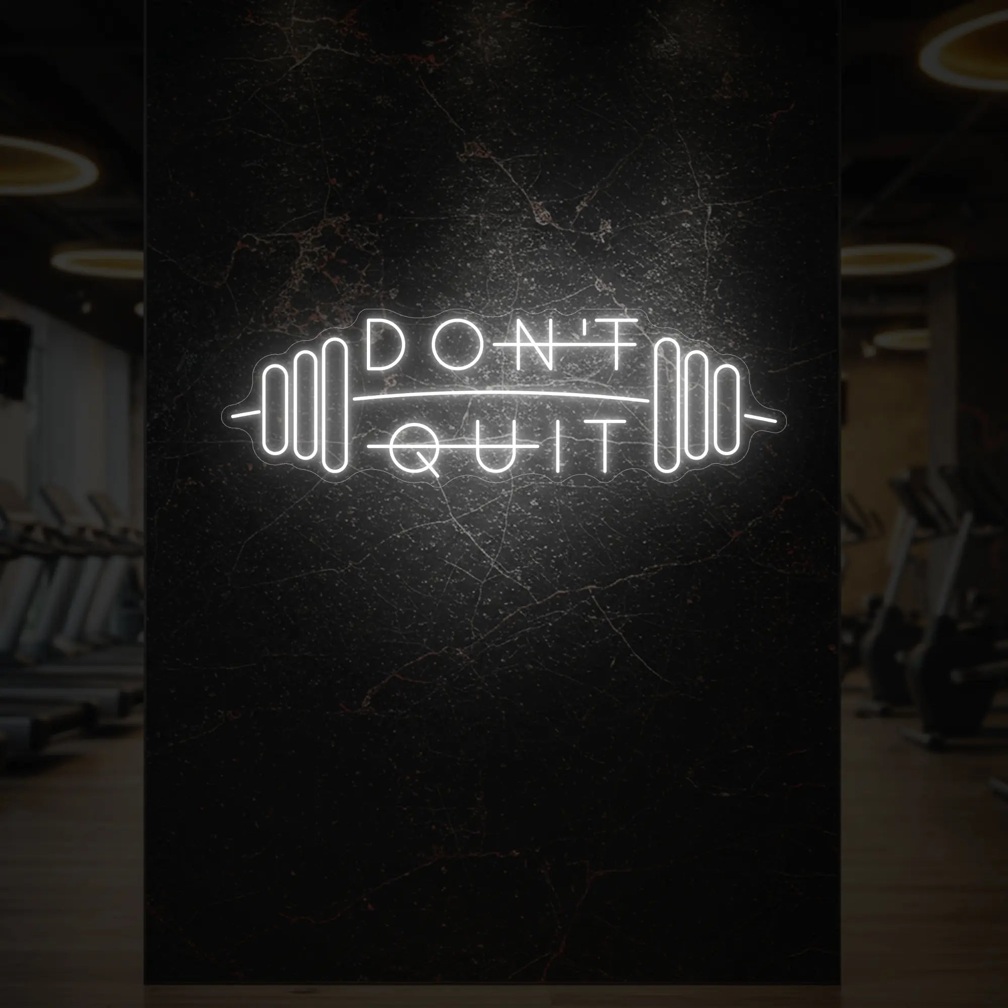 'Don’t Quit (with Barbell)' neon sign glowing in cool white against a styled interior wall.