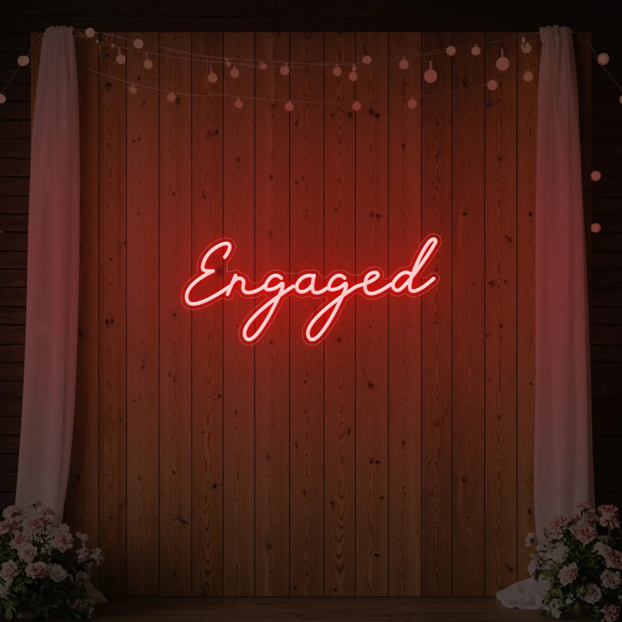 Photo of the 'Engaged' neon sign glowing in red against a styled interior wall.