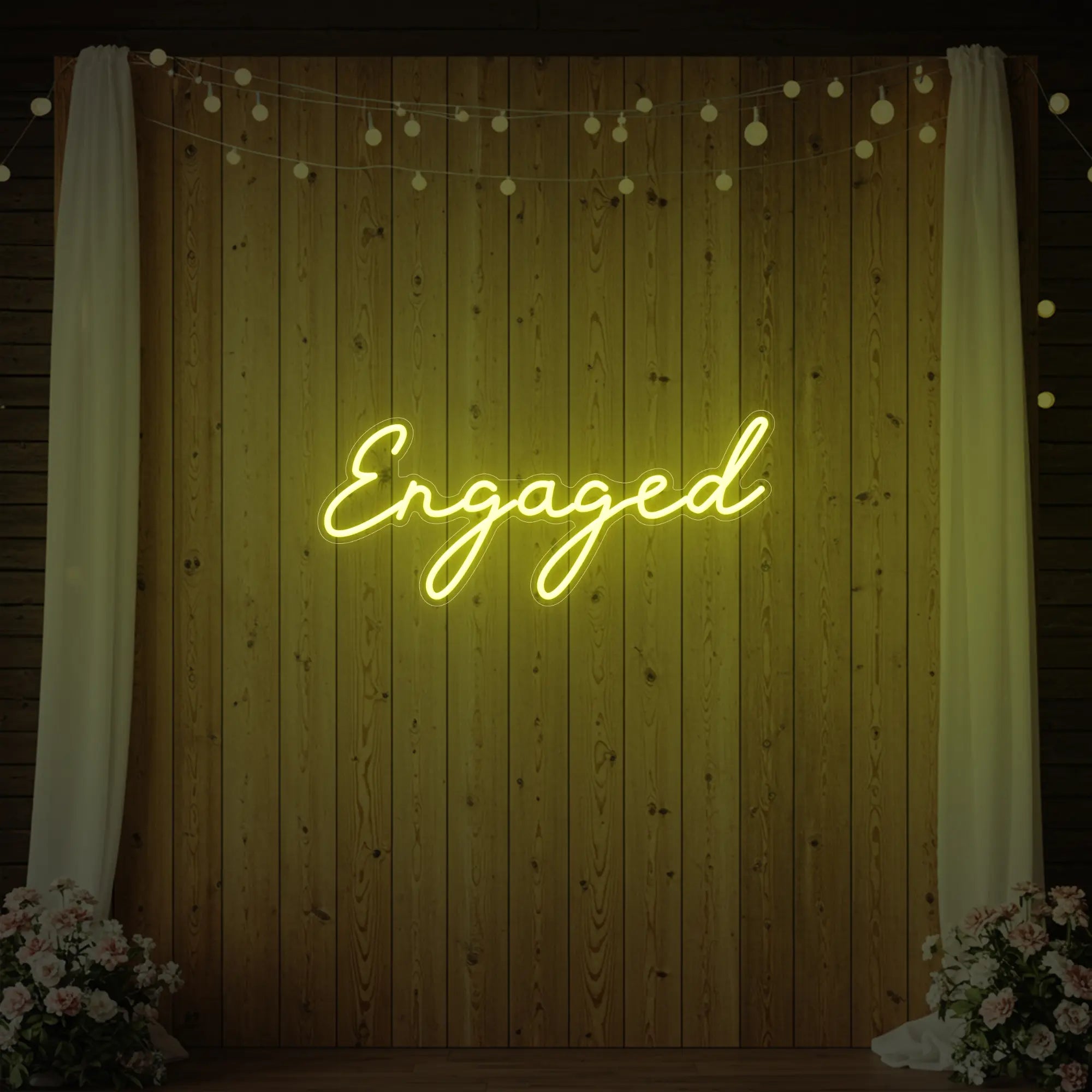 Photo of the 'Engaged' neon sign glowing in lemon yellow against a styled interior wall.