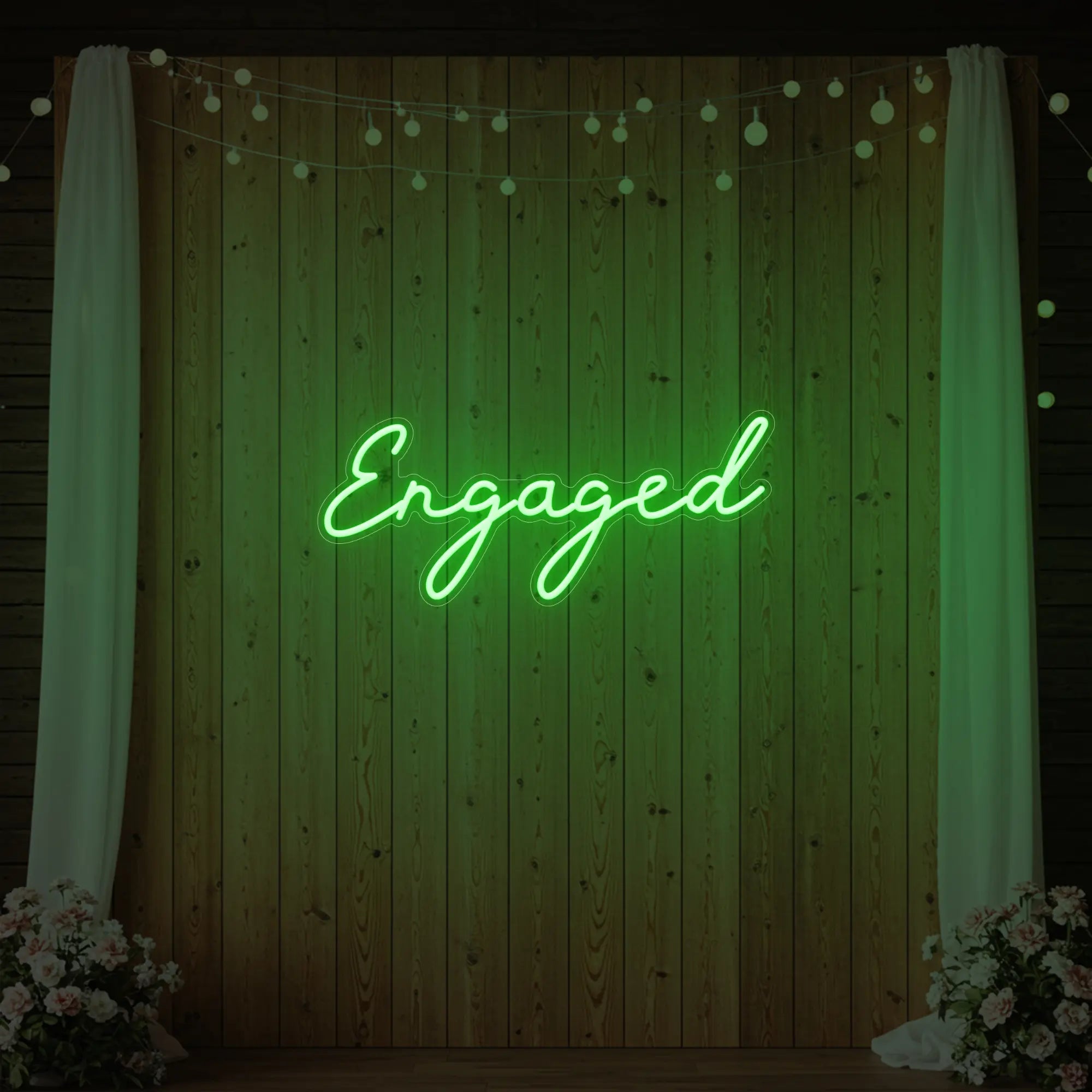 Photo of the 'Engaged' neon sign glowing in green against a styled interior wall.