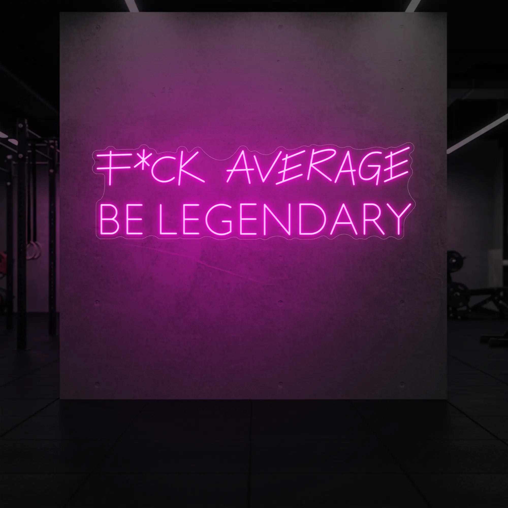 'F*ck Average Be Legendary' neon sign glowing in light pink against a styled interior wall.