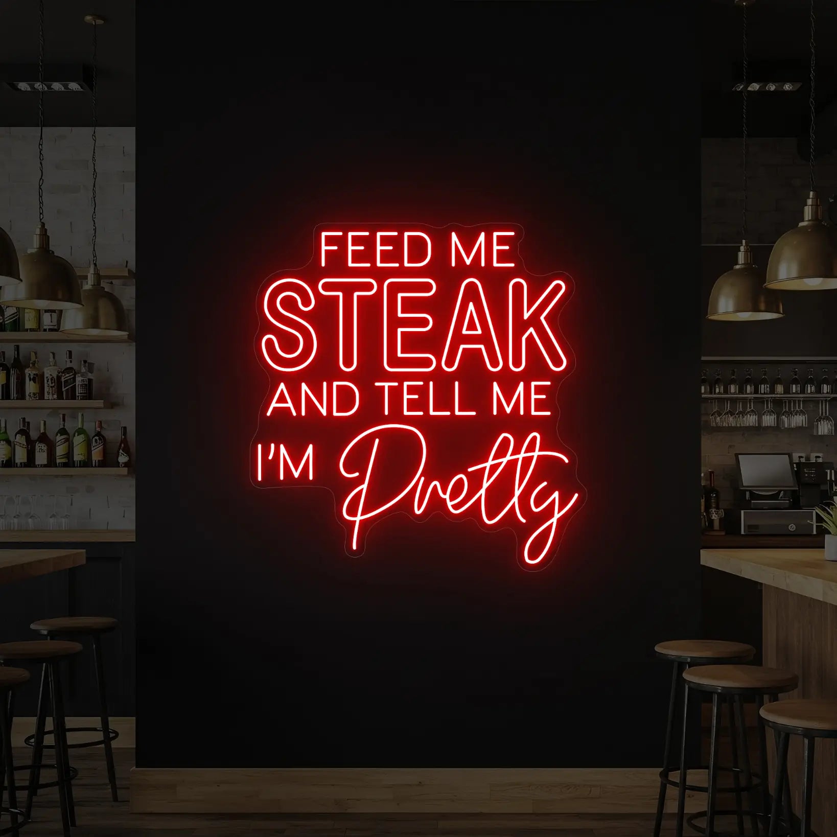 Photo of the 'Feed Me Steak And Tell Me I'm Pretty' neon sign glowing in red against a styled interior wall.