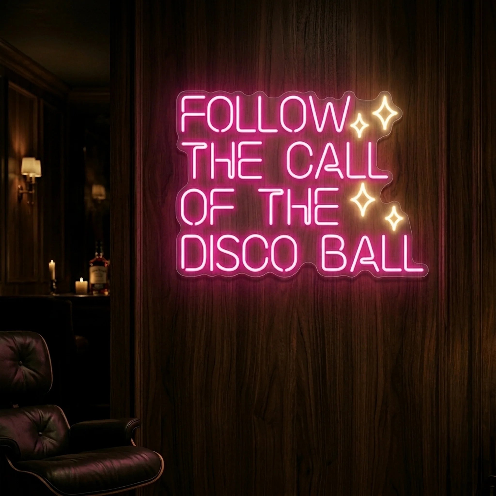 Photo of the 'Follow the Call of the Disco Ball' neon sign glowing in light pink and warm white against a styled interior wall.