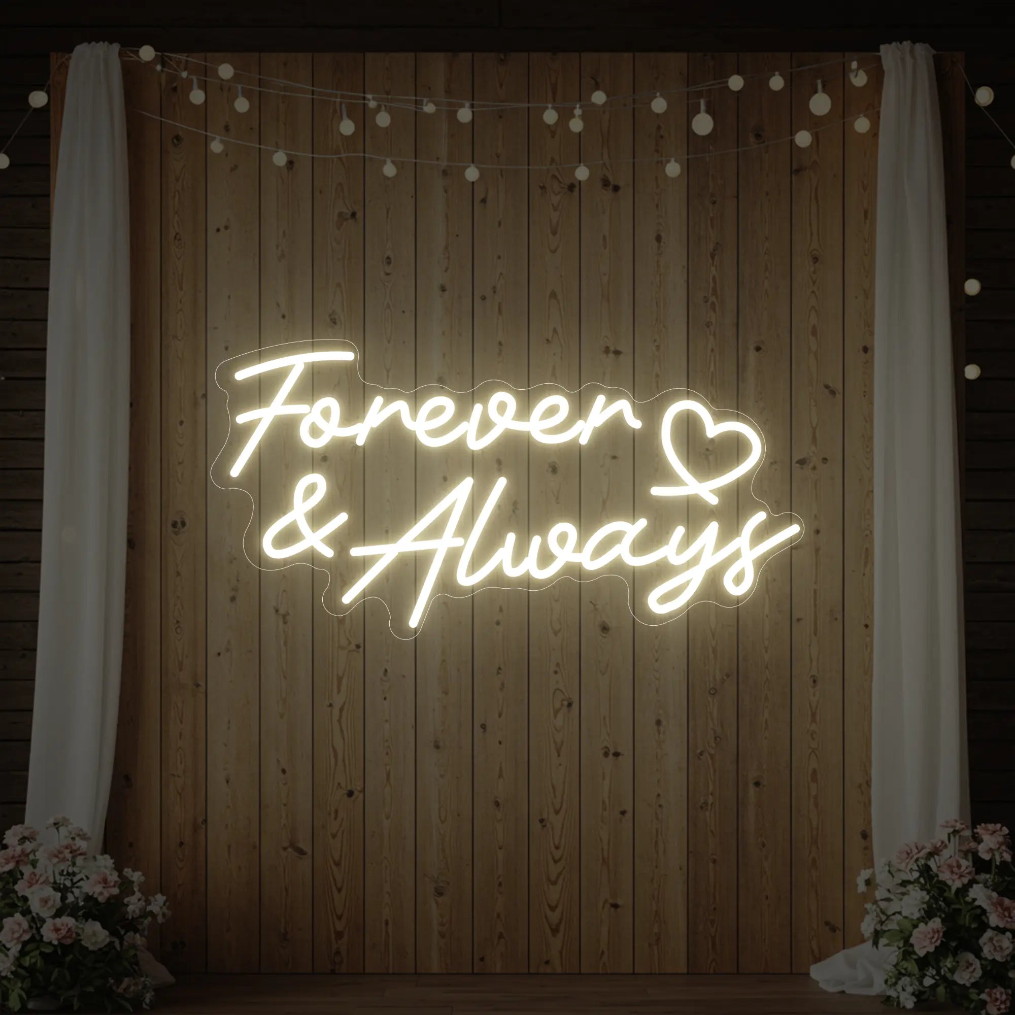 Photo of the 'Forever & Always' neon sign glowing in warm white against a styled interior wall.