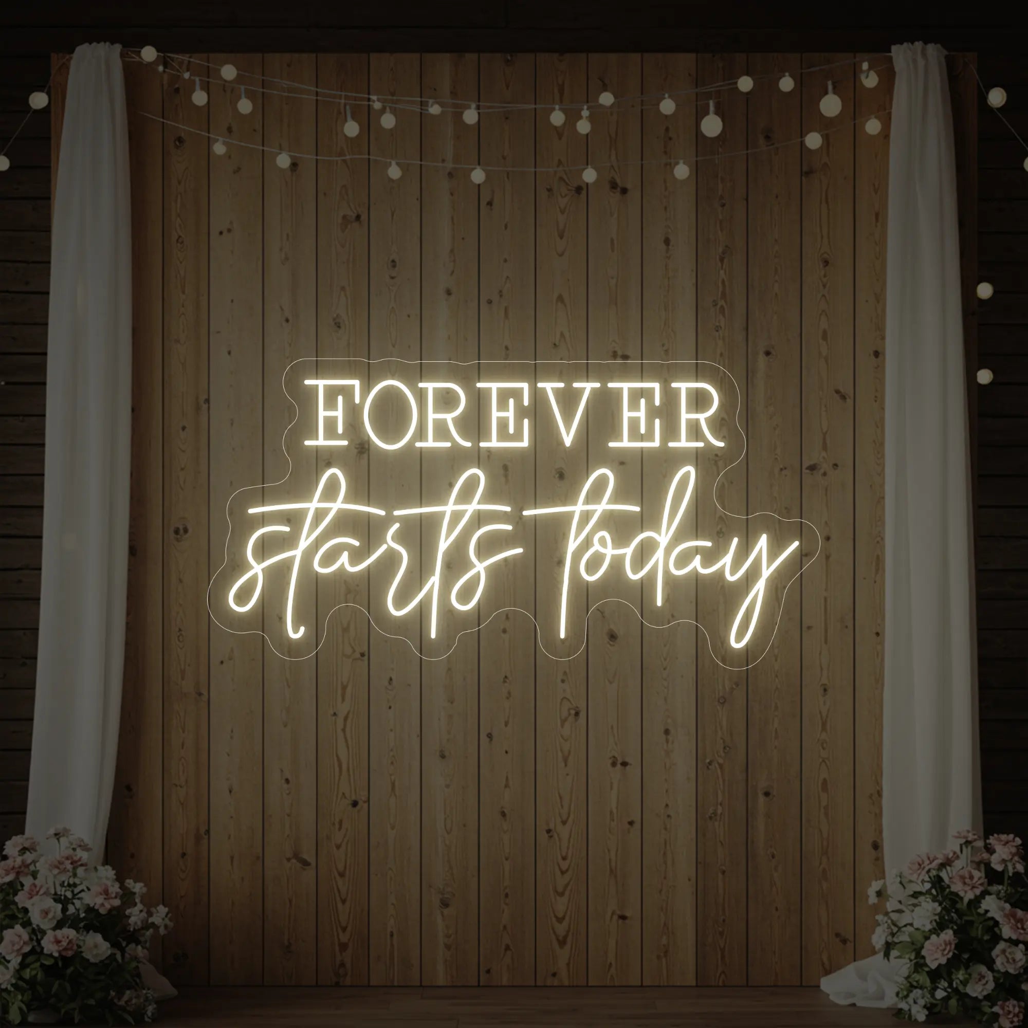 Photo of the 'Forever Starts Today' neon sign glowing in warm white against a styled interior wall.