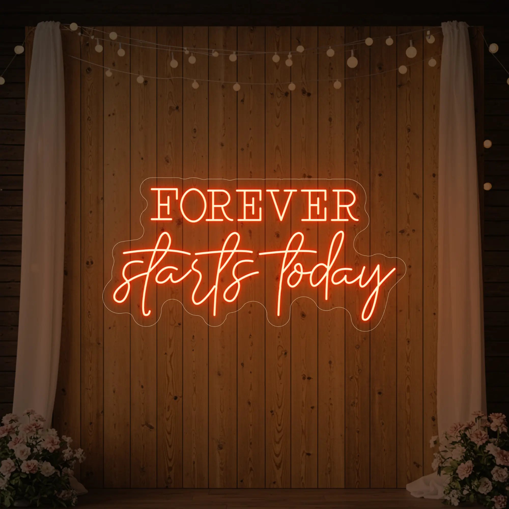 Photo of the 'Forever Starts Today' neon sign glowing in golden yellow against a styled interior wall.