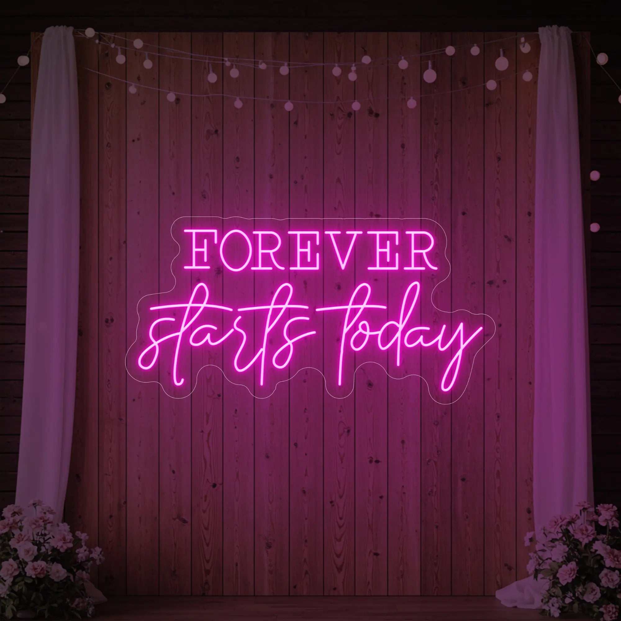 Photo of the 'Forever Starts Today' neon sign glowing in deep blue against a styled interior wall.