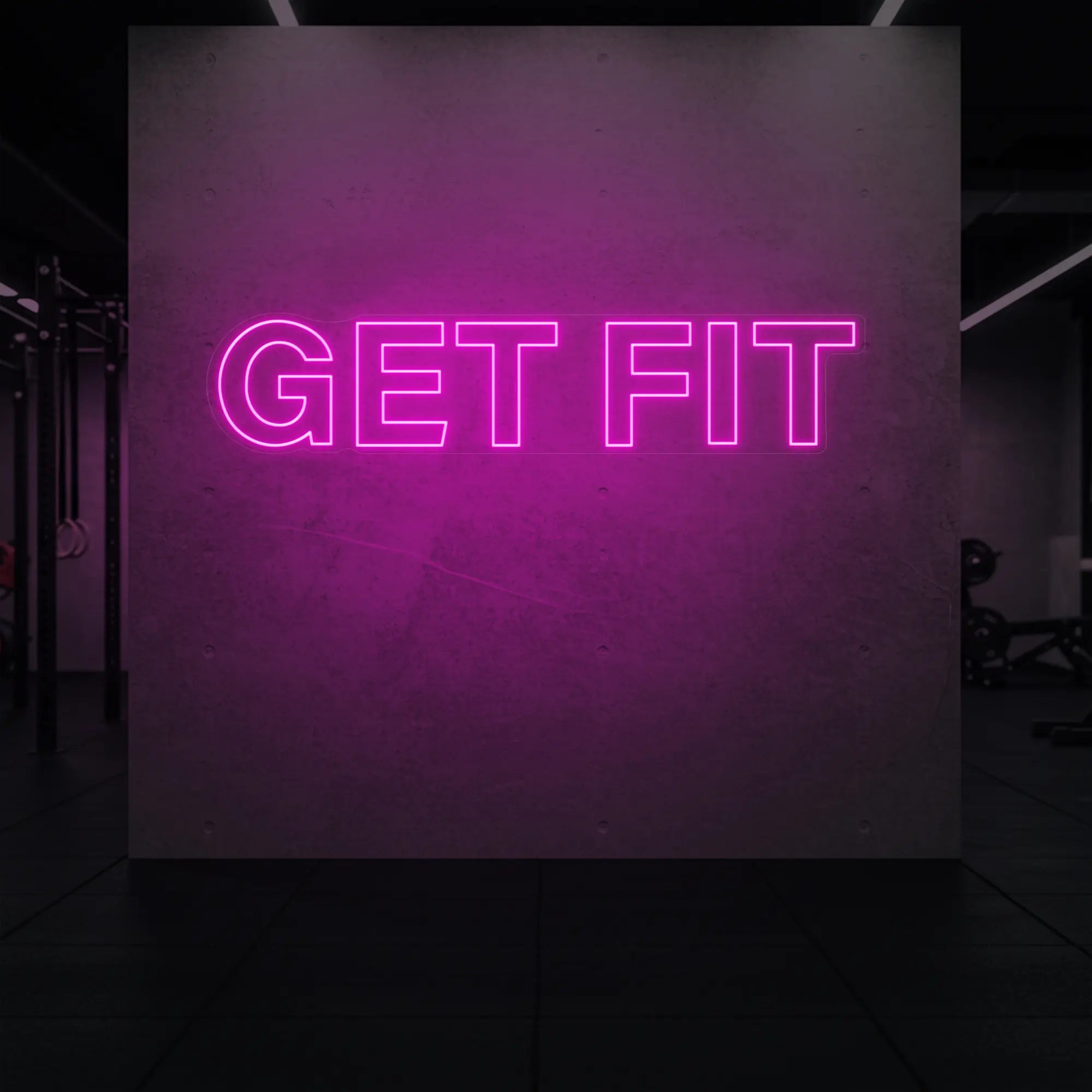 'Get Fit' neon sign glowing in light pink against a styled interior wall.